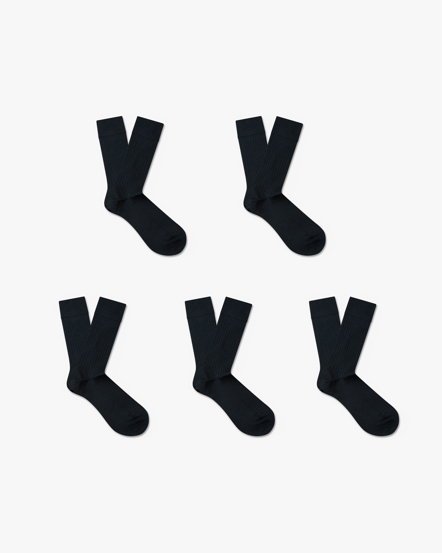 Product shot of Ludvig – Merino Wool Socks – 5-pack, with five pairs of black ribbed socks arranged on a white background.