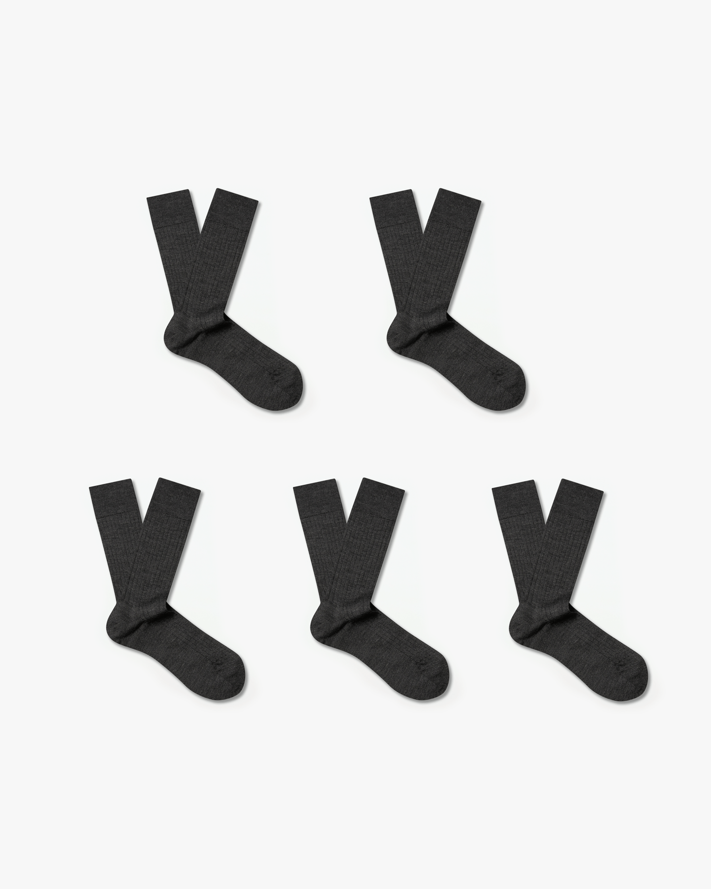 Five pairs of Ludvig – Merino Wool Socks in dark grey, laid flat against a white background.