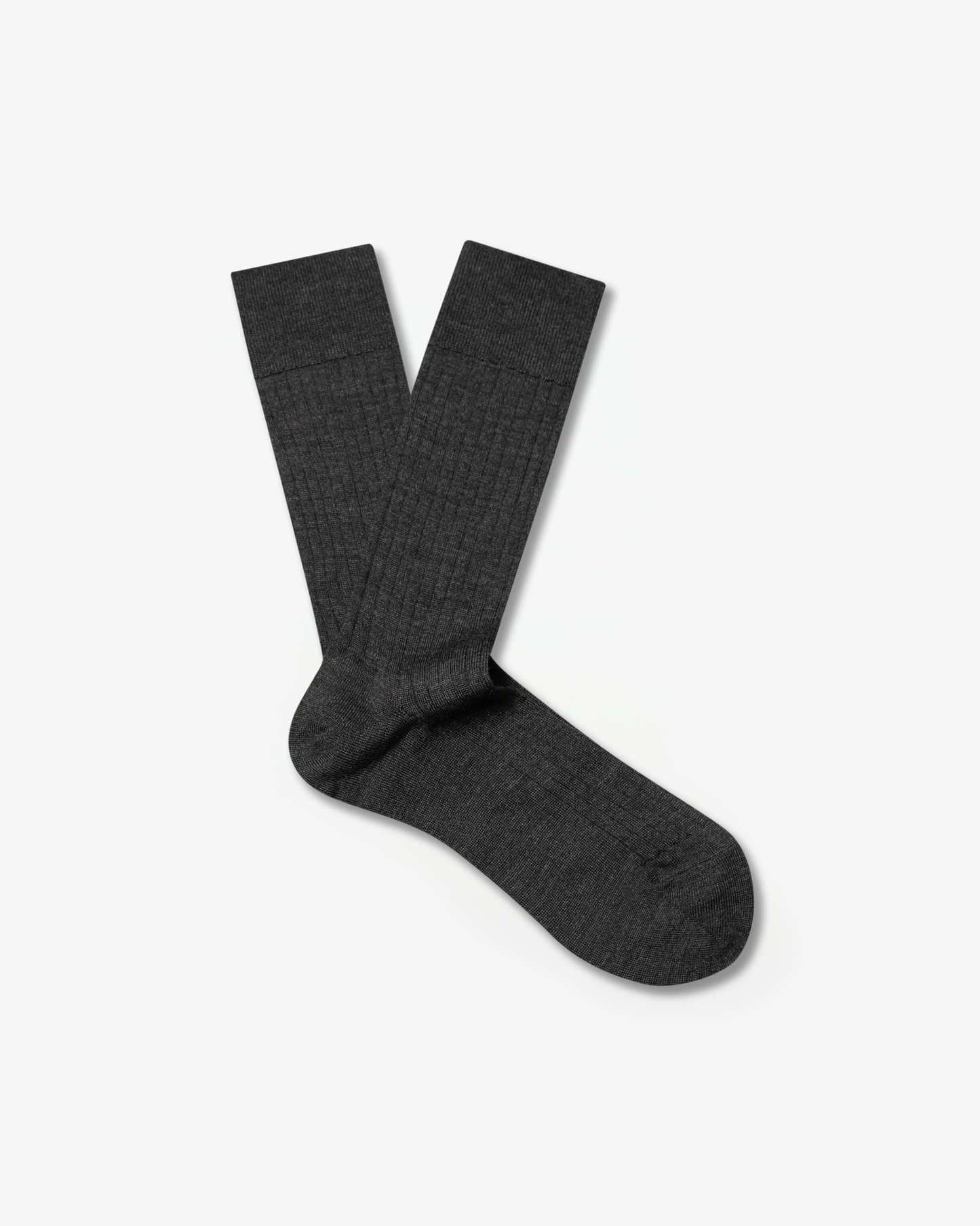 A pair of Ludvig – Merino Wool Socks in dark grey laid out against a white background.