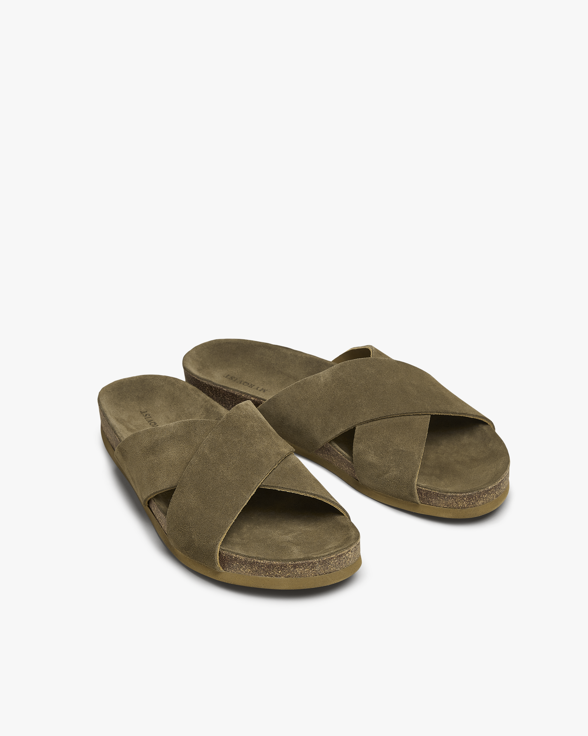 A pair of Solvik – Moss Green Suede sandals with crisscross straps and a cork sole, set against a white background.