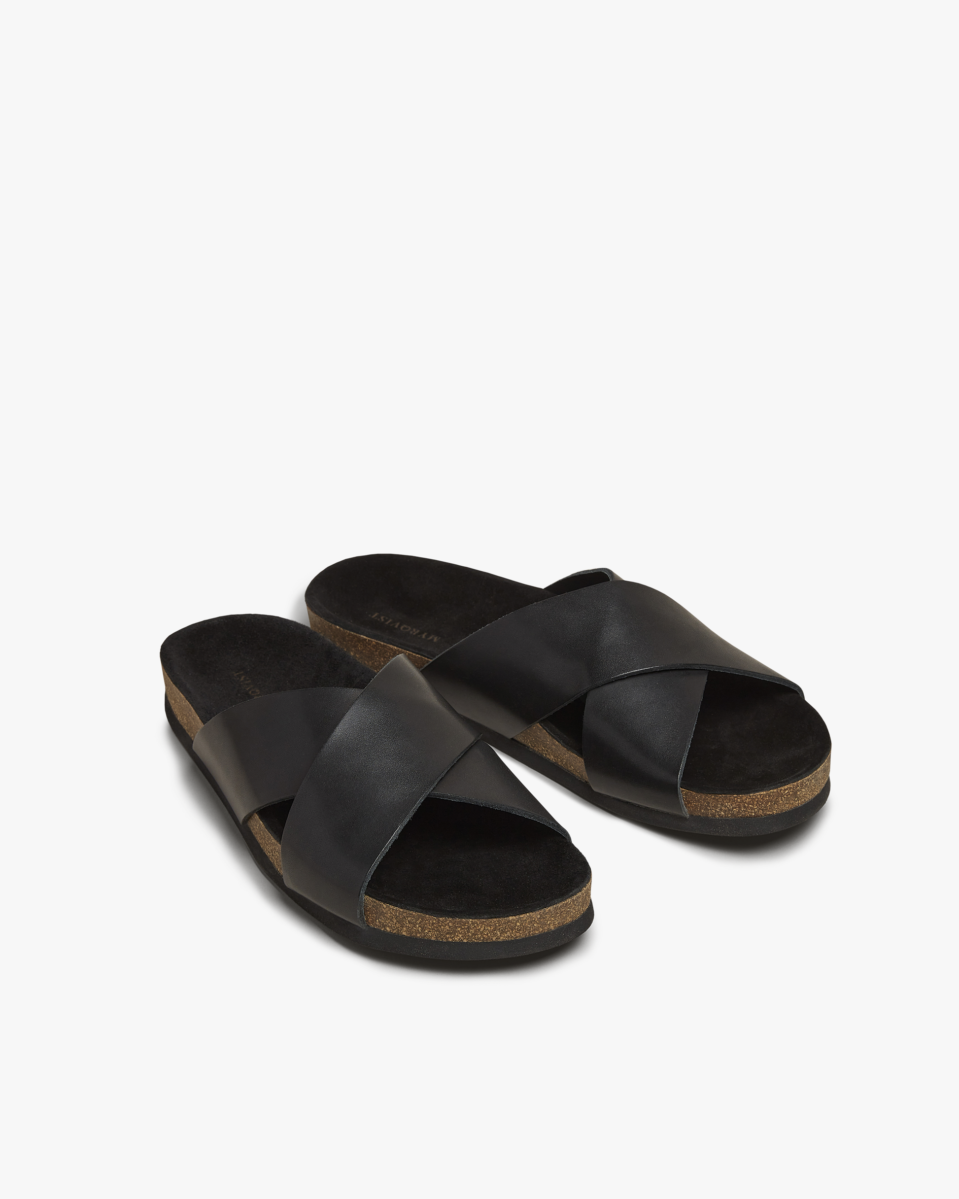 A pair of Solvik – Black Calf sandals with black leather cross-straps and a cork sole, shot against a white background.