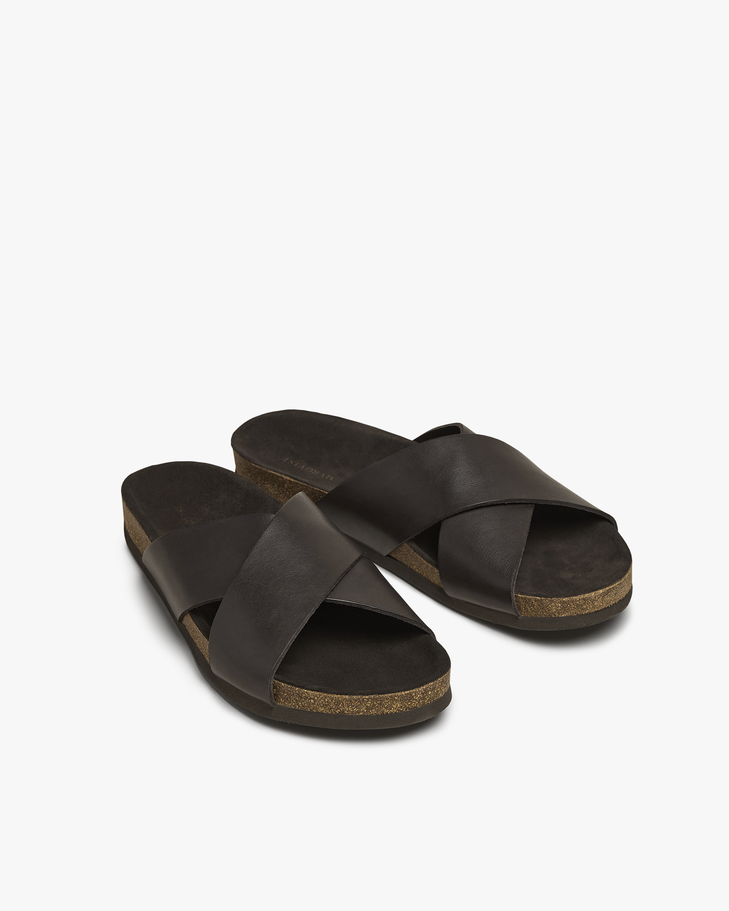 Solvik in dark brown calf showcases wide, criss-crossed leather straps and a cork sole with a soft suede insole, offering a refined and comfortable sandal ideal for warm weather and versatile summer outfits.