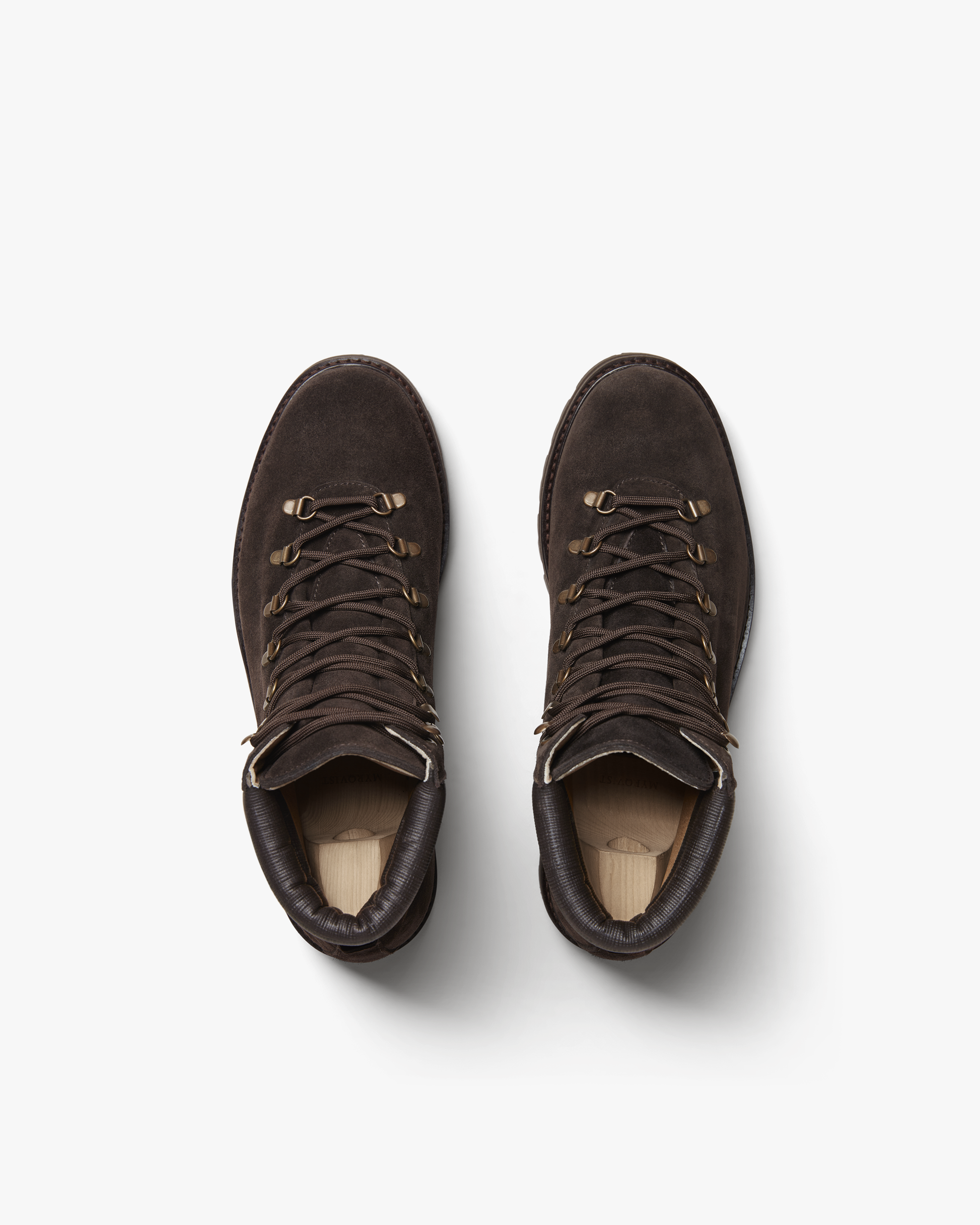 A pair of Duved II – Dark Brown Suede hiking boots with shoe trees, shot from above on a white background.