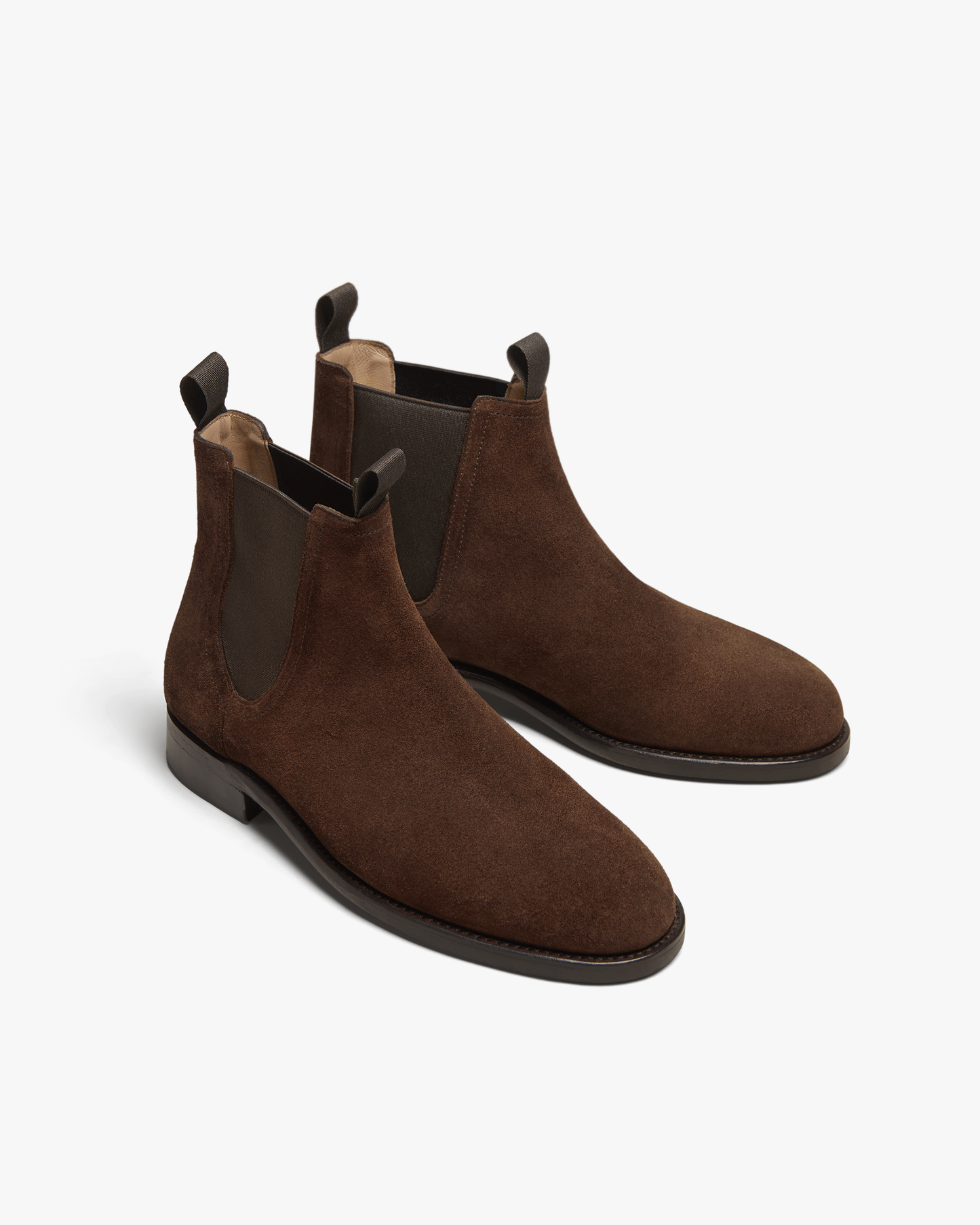 A pair of Elfvik – Dark Brown Suede Chelsea boots on a white background.