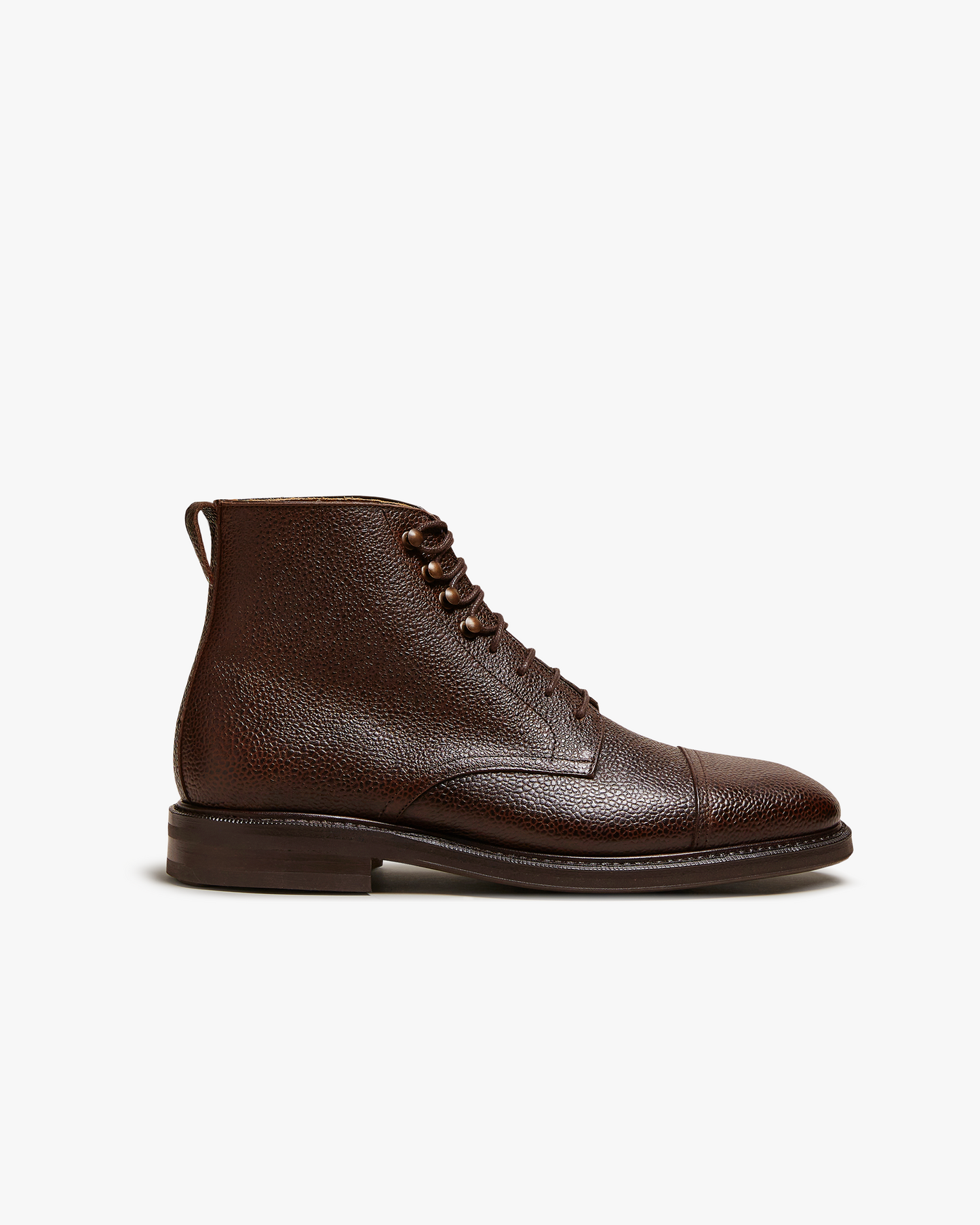 Side profile of Abisko – Dark Brown Country Calf jumper boot, showing its textured grain leather and cap toe.
