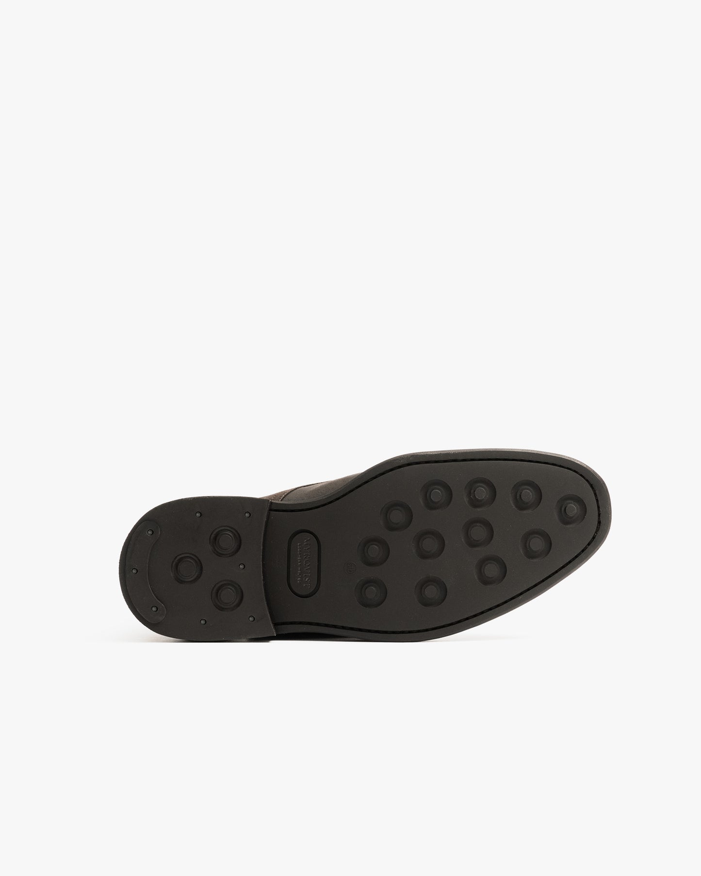 Abisko in brown waxed suede shown from the bottom, featuring a double studded rubber sole designed for reliable traction and durability in winter conditions.