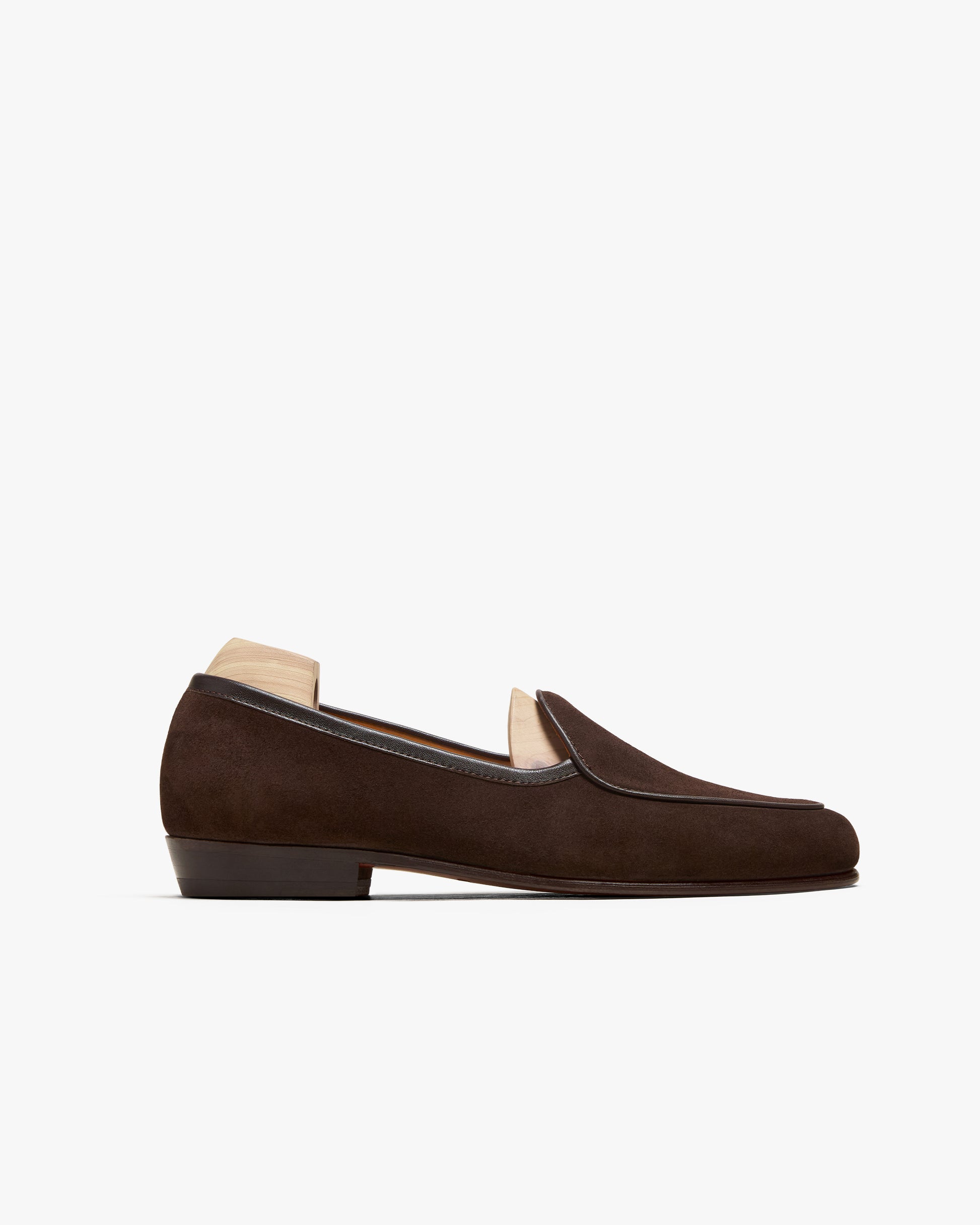 A side profile view of Ängby – Dark Brown Suede, showcasing the Belgian loafer's silhouette against a white background.