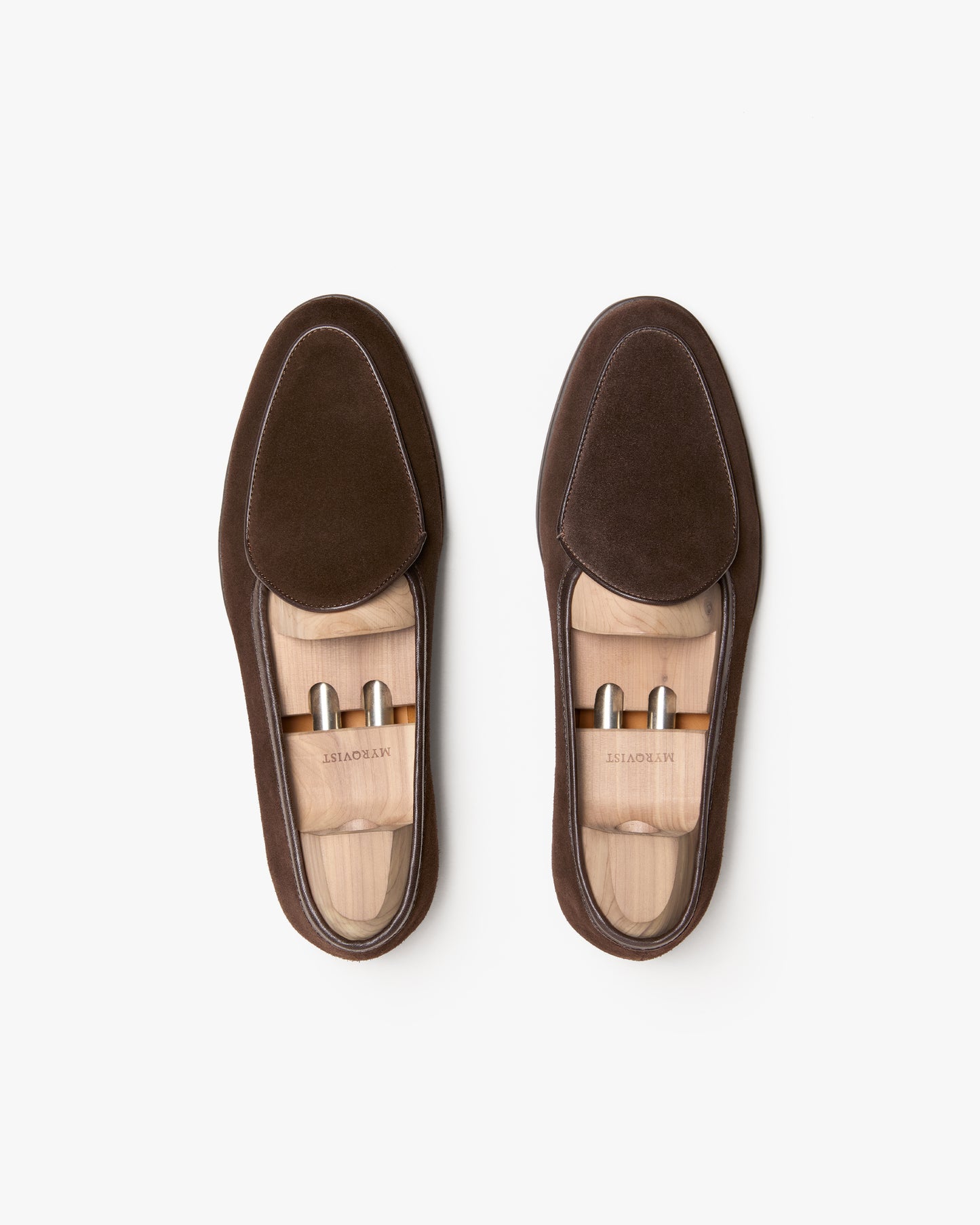 A top-down view of Ängby Walker – Dark Brown Suede loafers, displayed with wooden shoe trees on a white background.