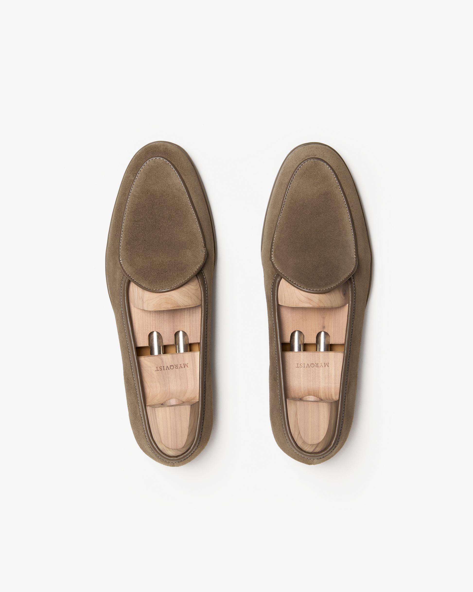 A top-down view of Ängby Walker – Taupe Suede loafers, presented with wooden shoe trees on a white background.