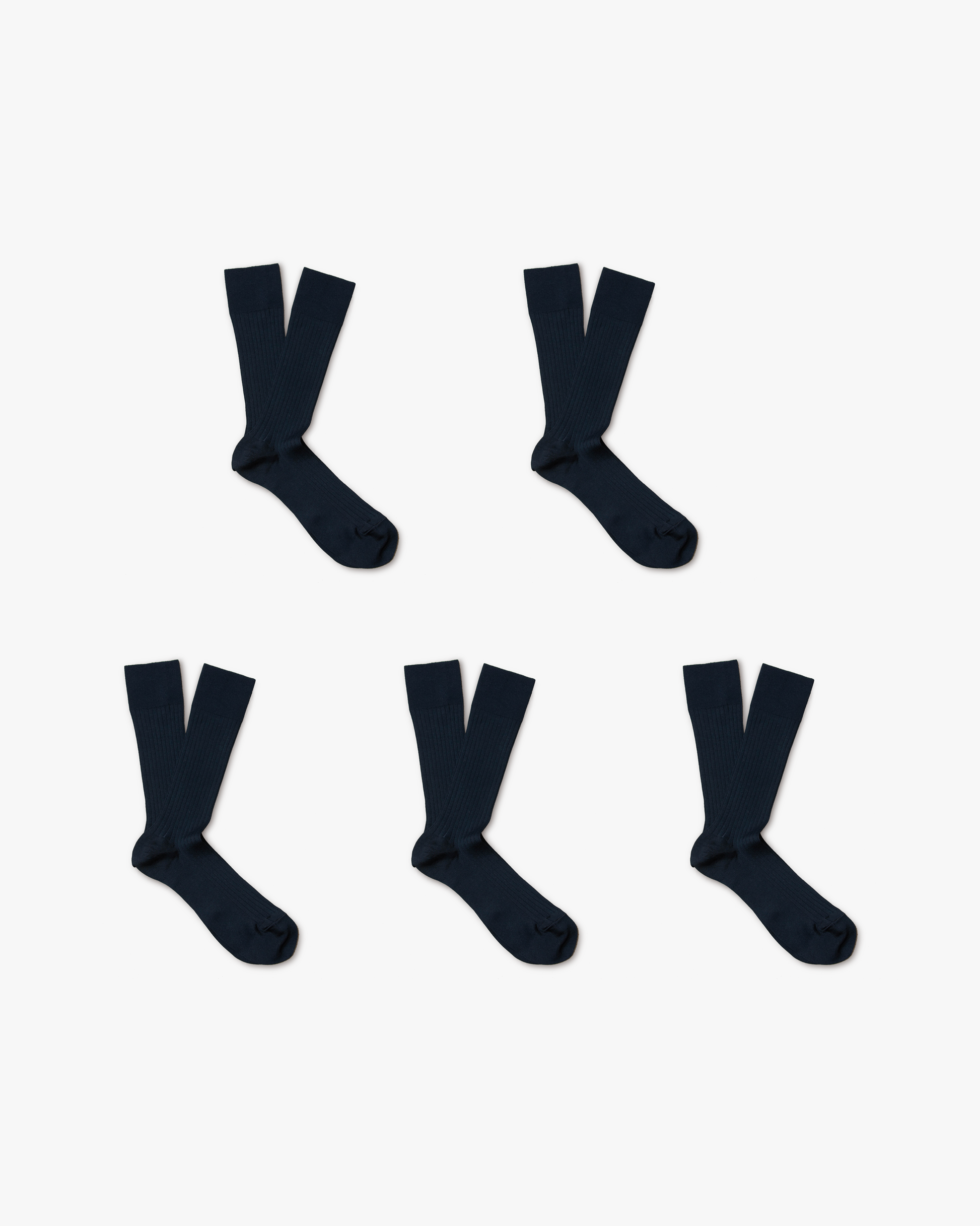 A flat lay of five pairs of navy ribbed Axel cotton socks arranged on a white background.