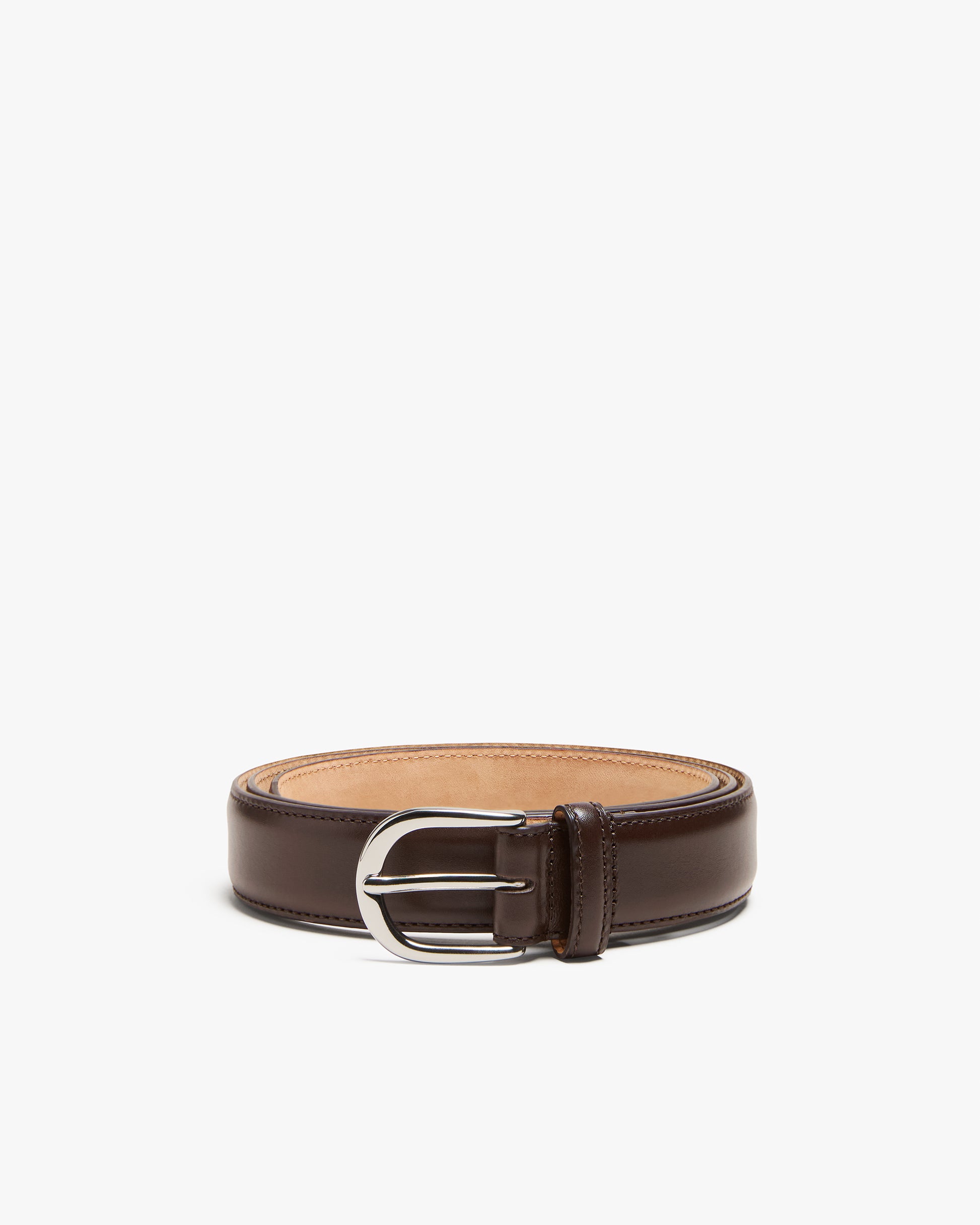 A studio shot of the coiled Belt – Dark Brown Leather, highlighting its 30mm rounded silver buckle.