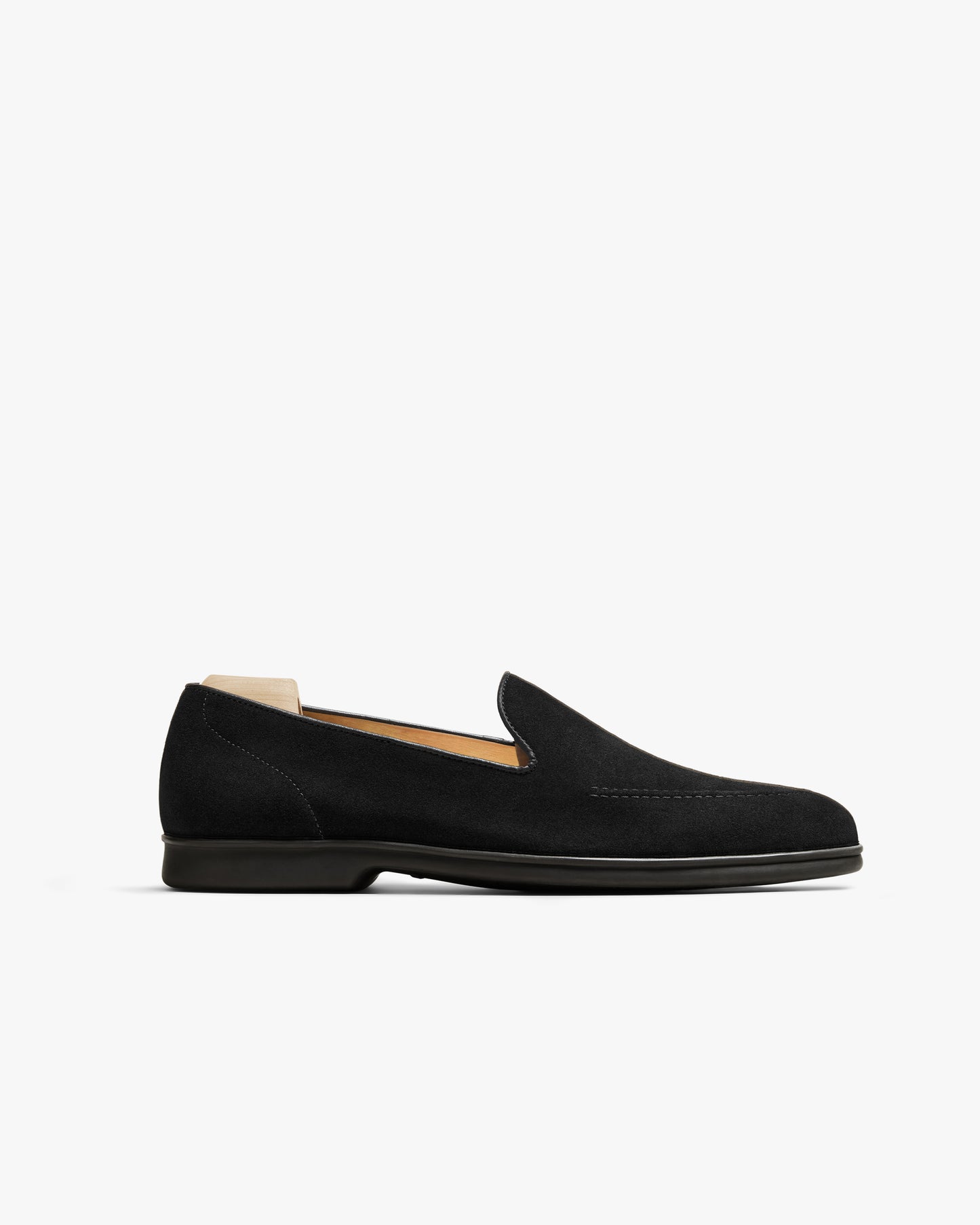 A side profile of the Brännö II – Black Suede loafer, highlighting its sleek silhouette and matching black rubber sole.