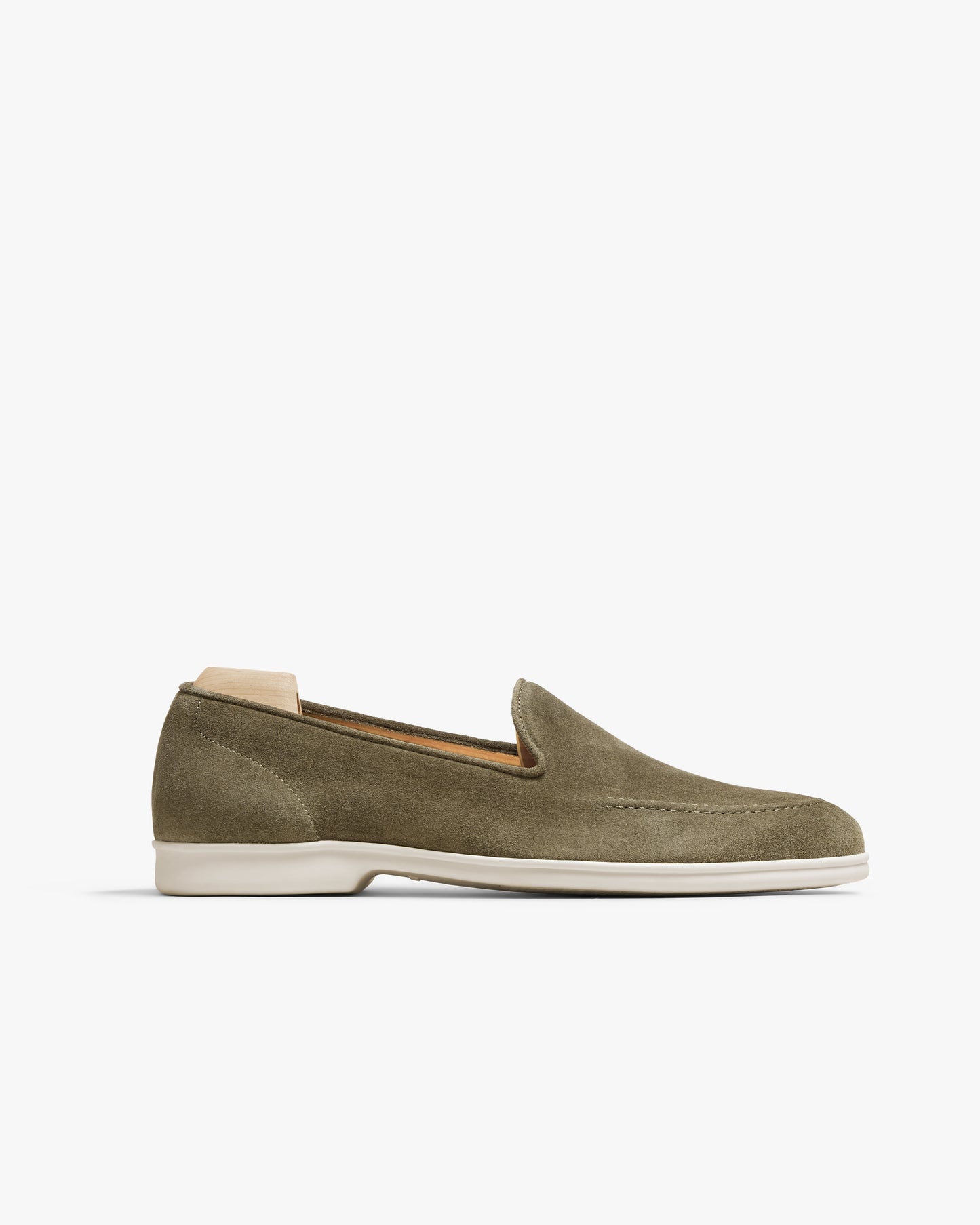 Side profile of the Brännö II loafer in moss green suede, showcasing its sleek silhouette and the off-white rubber sole.