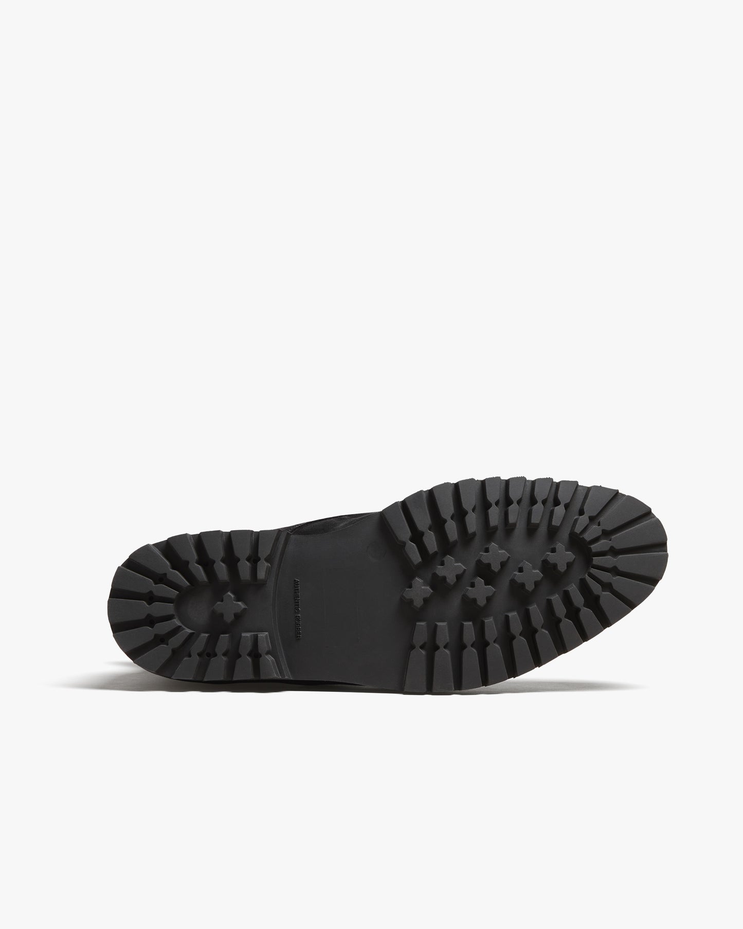 A close-up of the commando sole of Gothem – Black Suede, detailing its rugged tread for durability and grip.