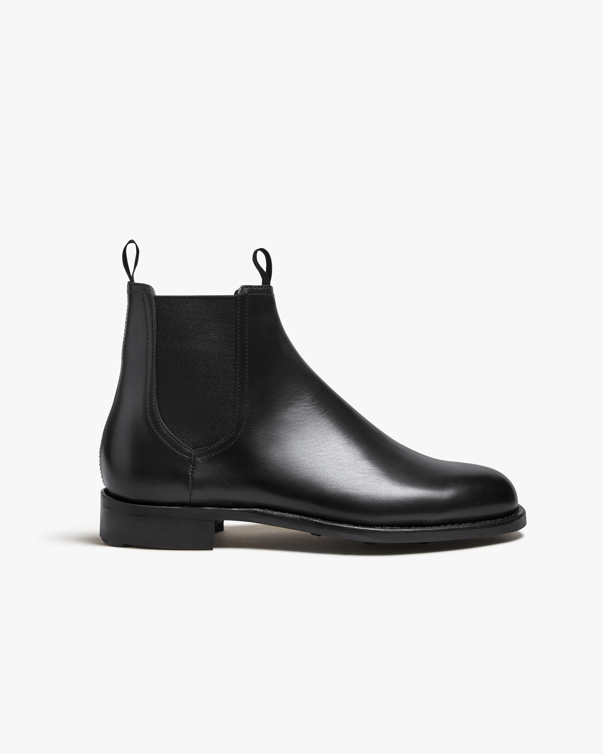A side profile of the Elfvik – Black Calf Chelsea boot, highlighting its classic silhouette and smooth leather.