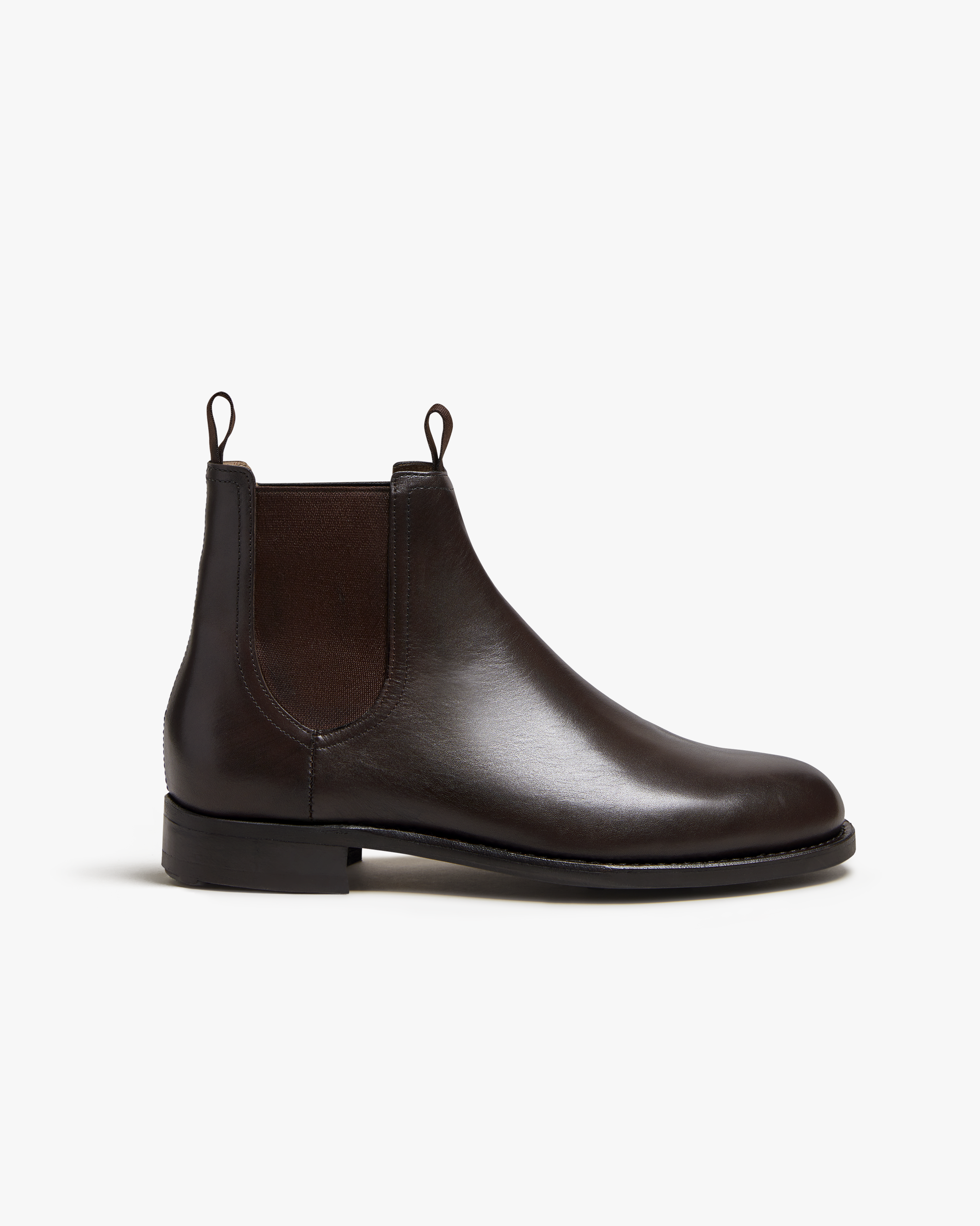 A side profile of the Elfvik – Dark Brown Calf Chelsea boot, showcasing its sleek silhouette and rich leather.