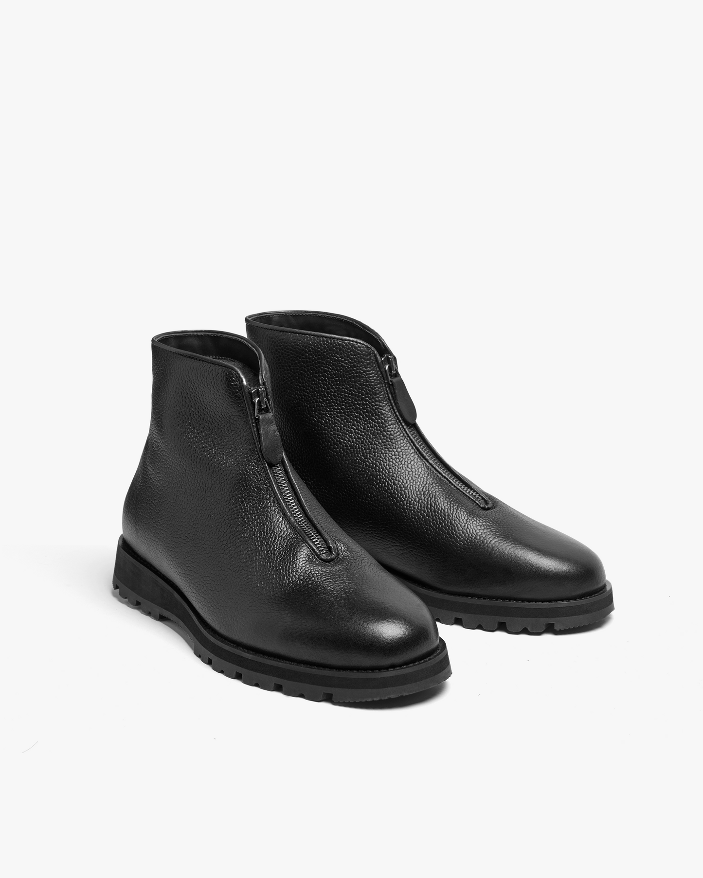 A pair of Funäs – Black Country Calf boots on a white background, showing the central zipper and grained leather.