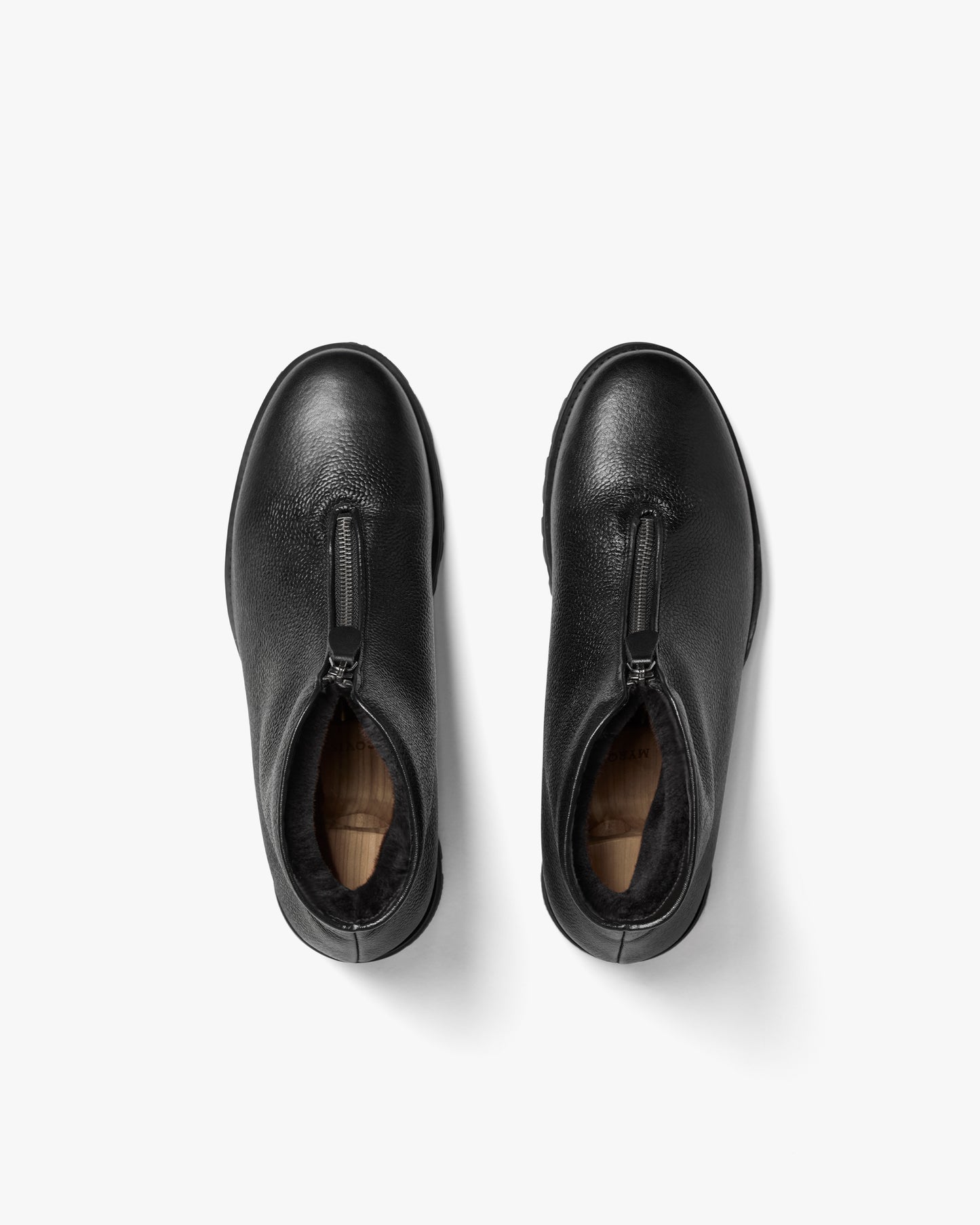 A top-down shot of Funäs – Black Country Calf boots, detailing the front zipper and shearling-lined interior.