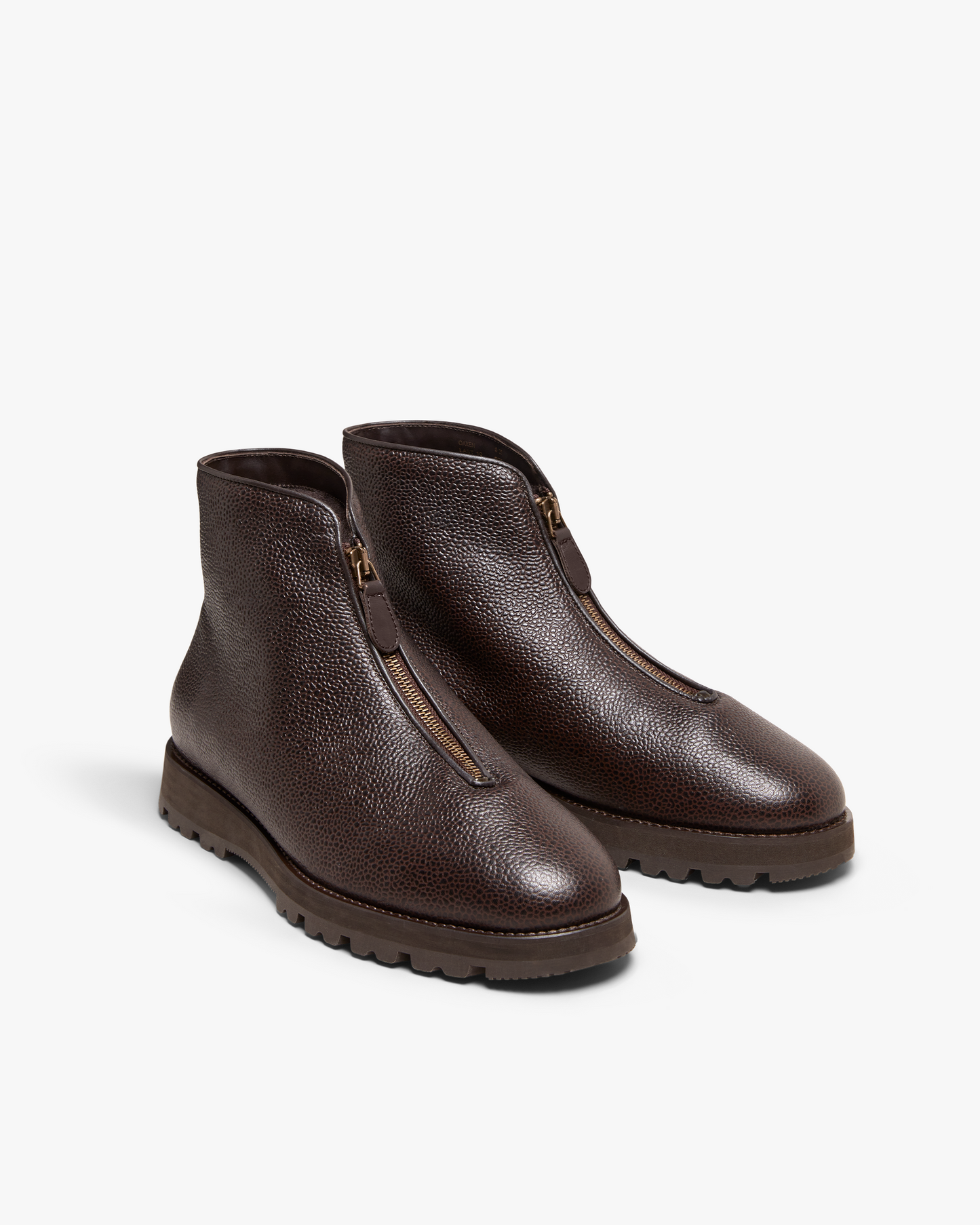 A studio shot of the Funäs – Dark Brown Country Calf boots, showing the textured leather, front zipper, and hiking sole.