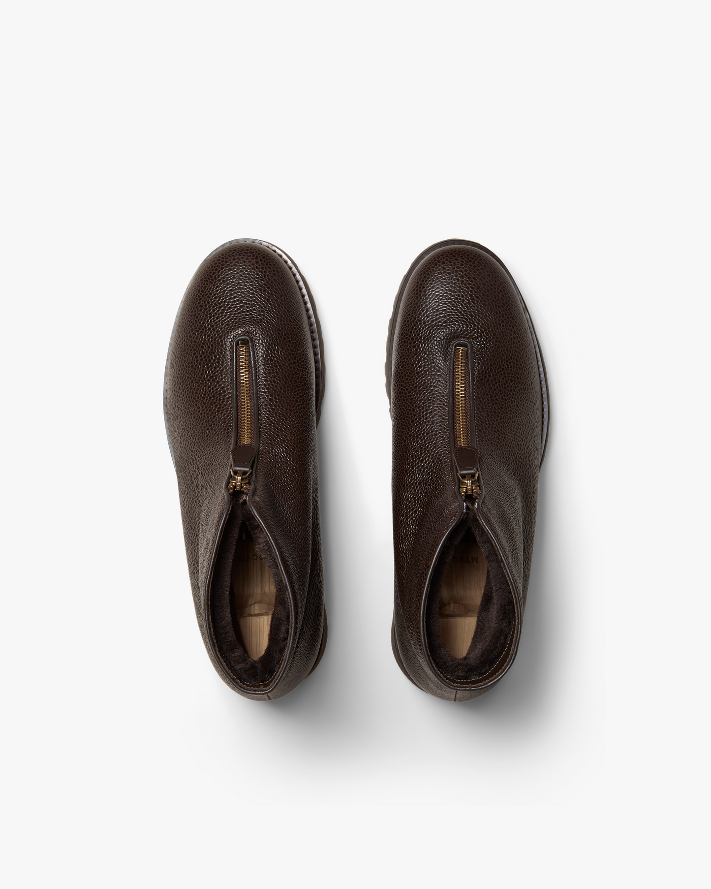 An overhead view of Funäs – Dark Brown Country Calf boots, showcasing the zipper closure and shearling lining.