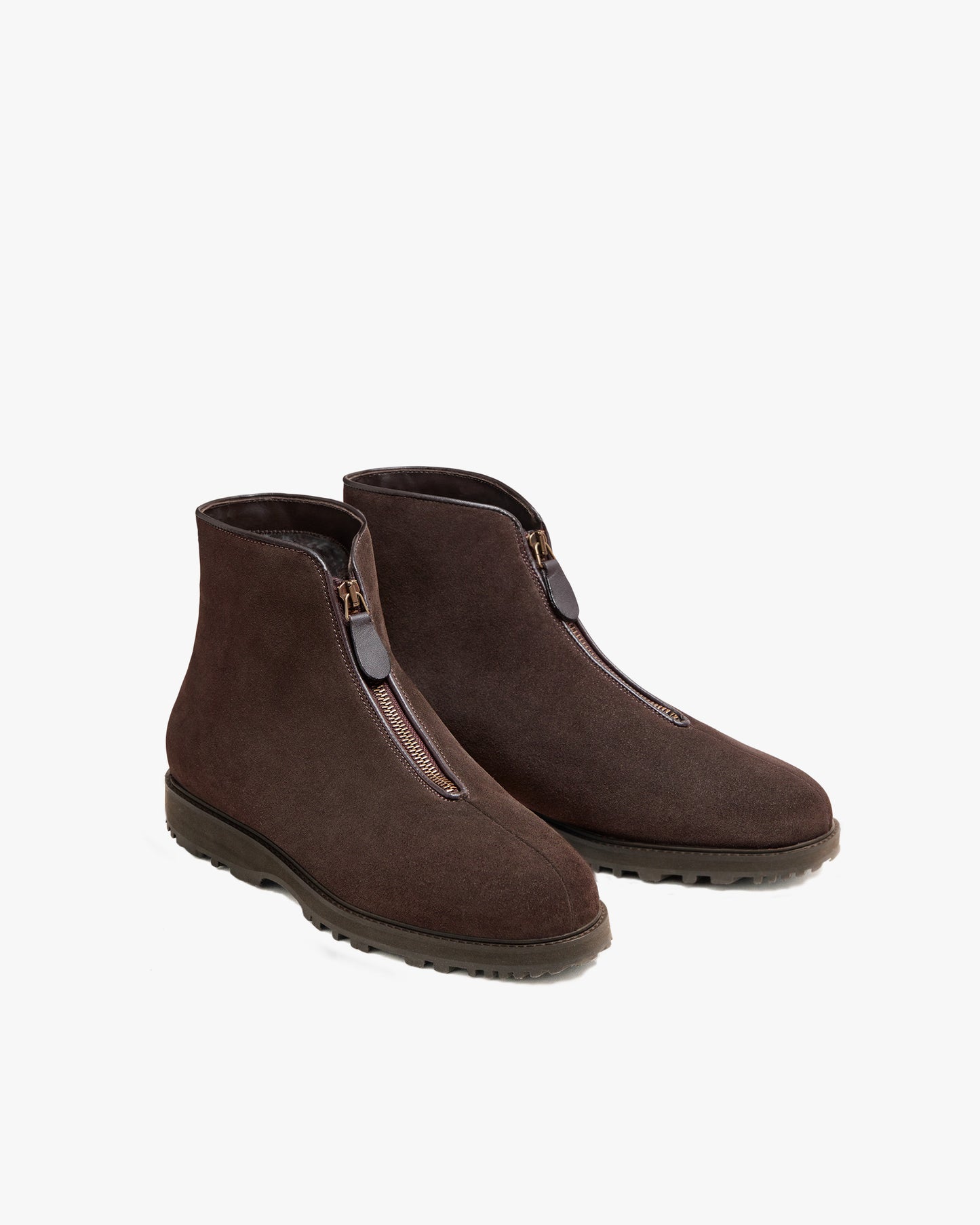 A pair of Funäs – Dark Brown Suede boots, shot against a white background to highlight the front zipper and robust sole.