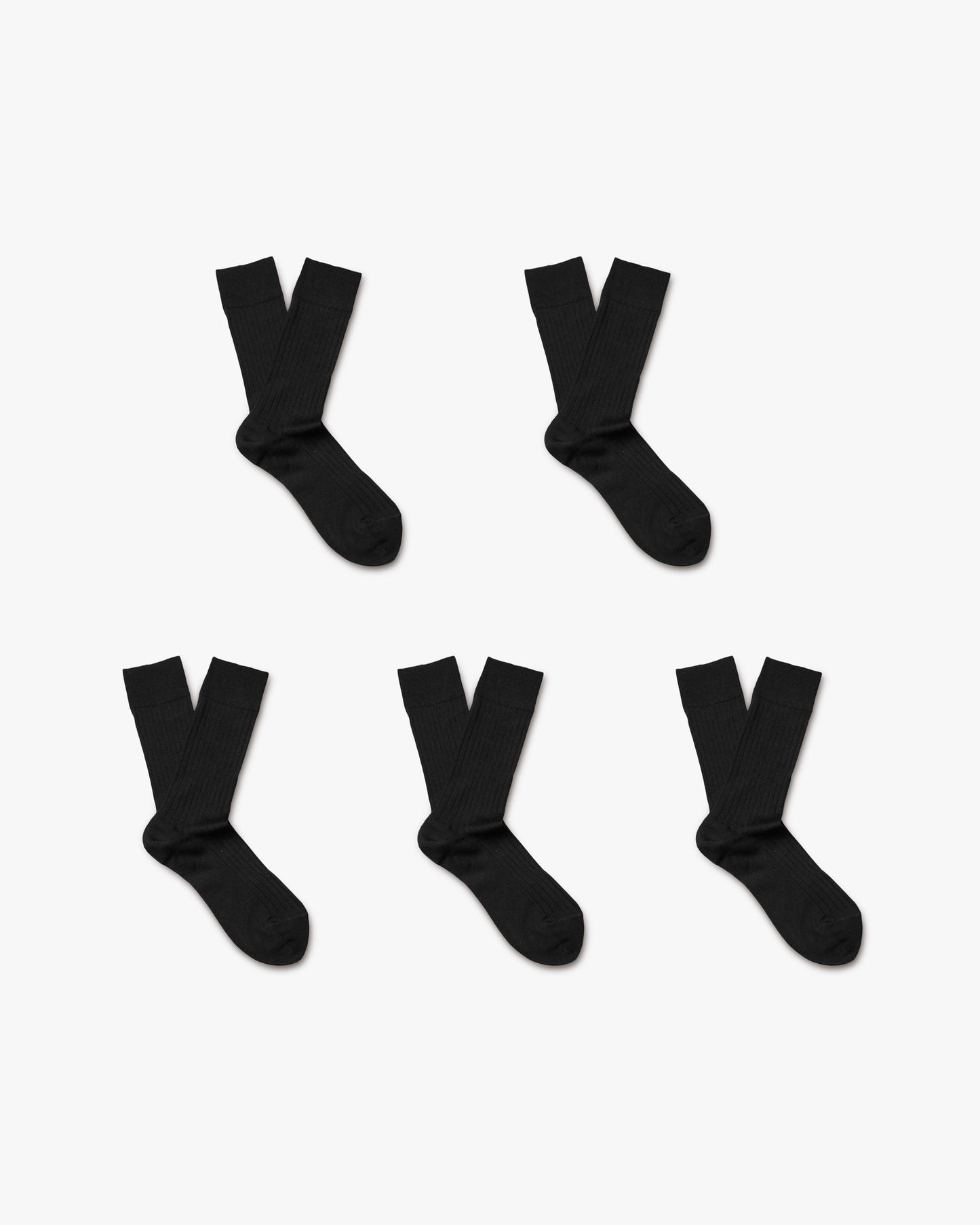 Five pairs of black ribbed Ludvig – Merino Wool Socks, from the 5-pack, arranged on a white background.