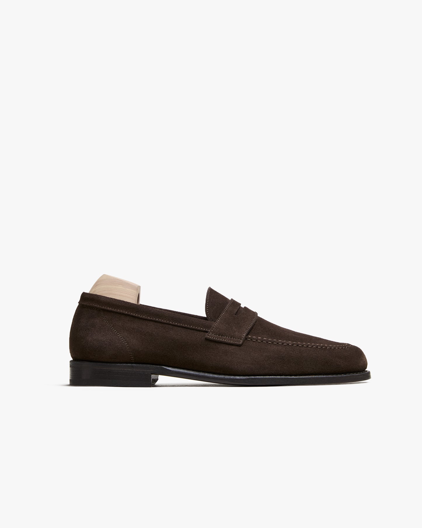 A side profile view of the Lysekil II – Dark Brown Suede loafer, detailing its silhouette and leather sole.