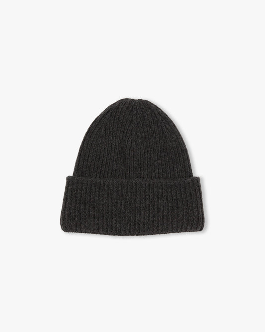 A studio shot of the Myrqvist Hat – Merino/Cashmere – Dark Grey, showing its ribbed knit texture and folded cuff.