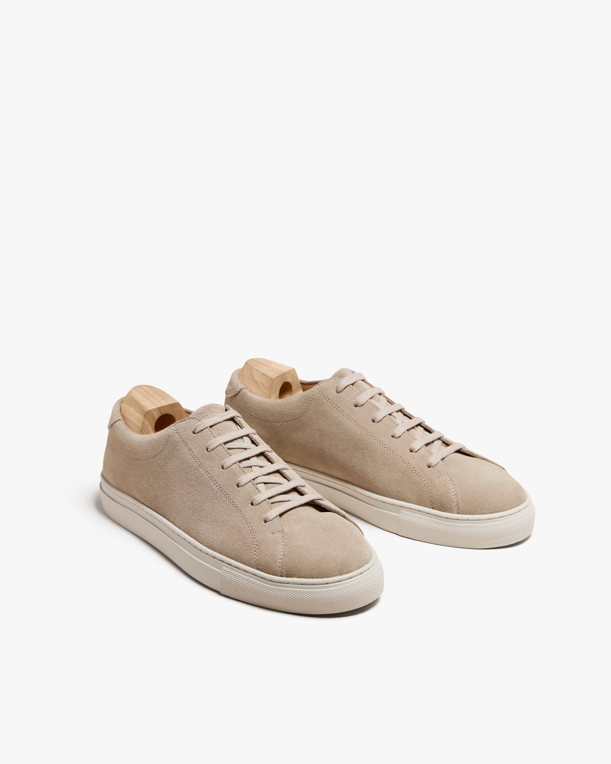 A pair of Oaxen II – Sand Suede sneakers with shoe trees, shown against a clean white background.