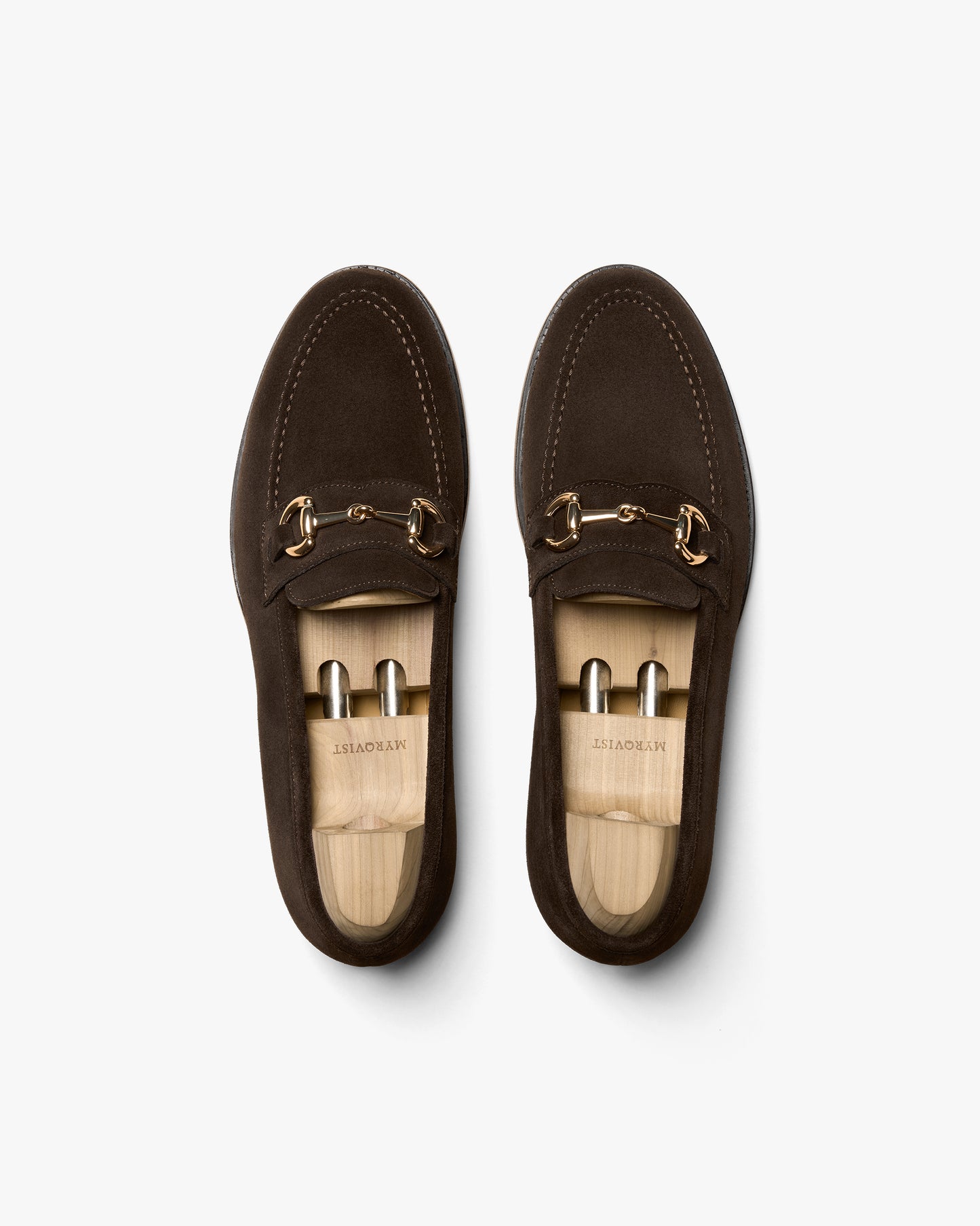 Overhead view of Karlberg – Dark Brown Suede loafers with wooden shoe trees, against a white background.