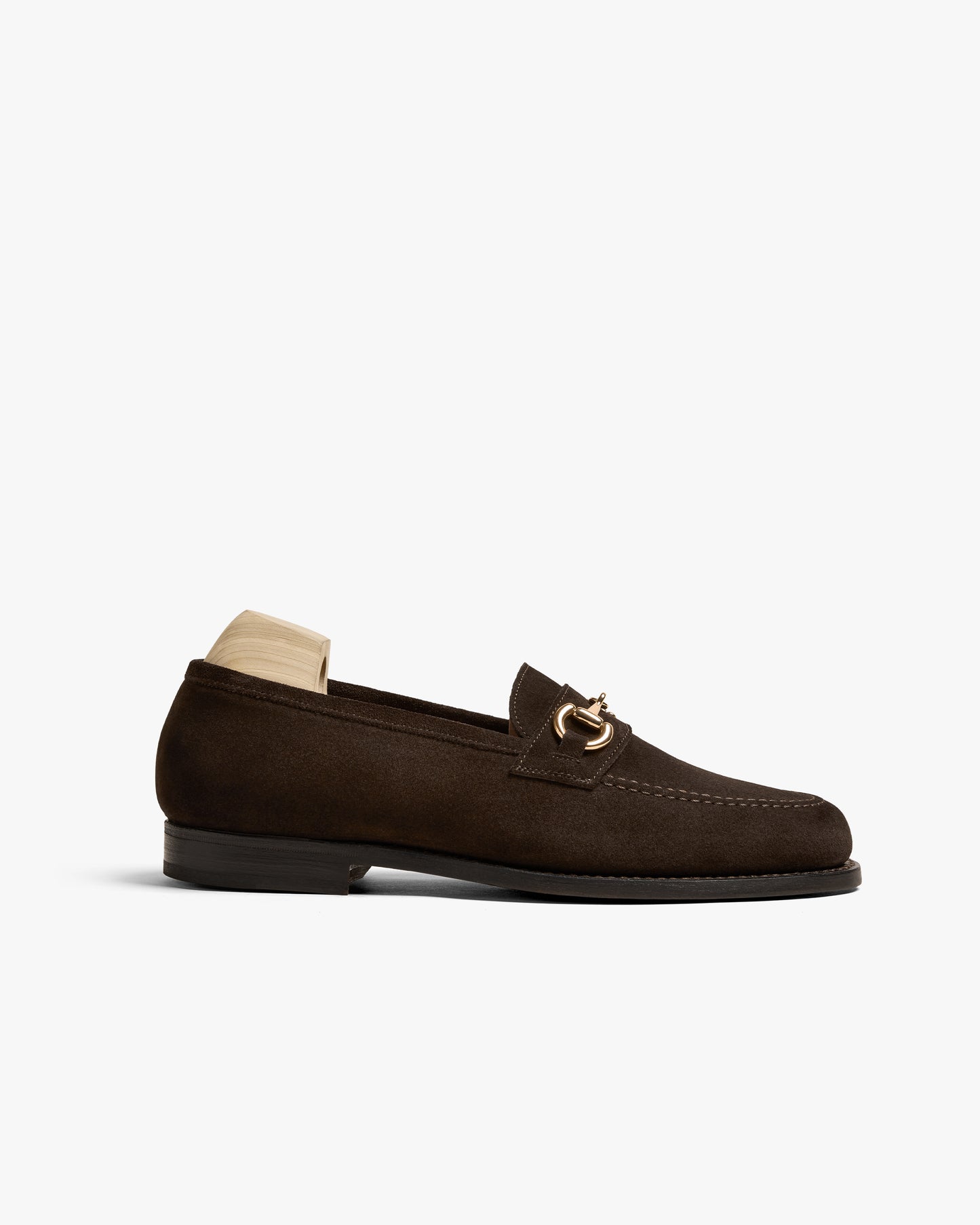 A side profile of Karlberg – Dark Brown Suede, a horsebit loafer, highlighting its silhouette and gold hardware.