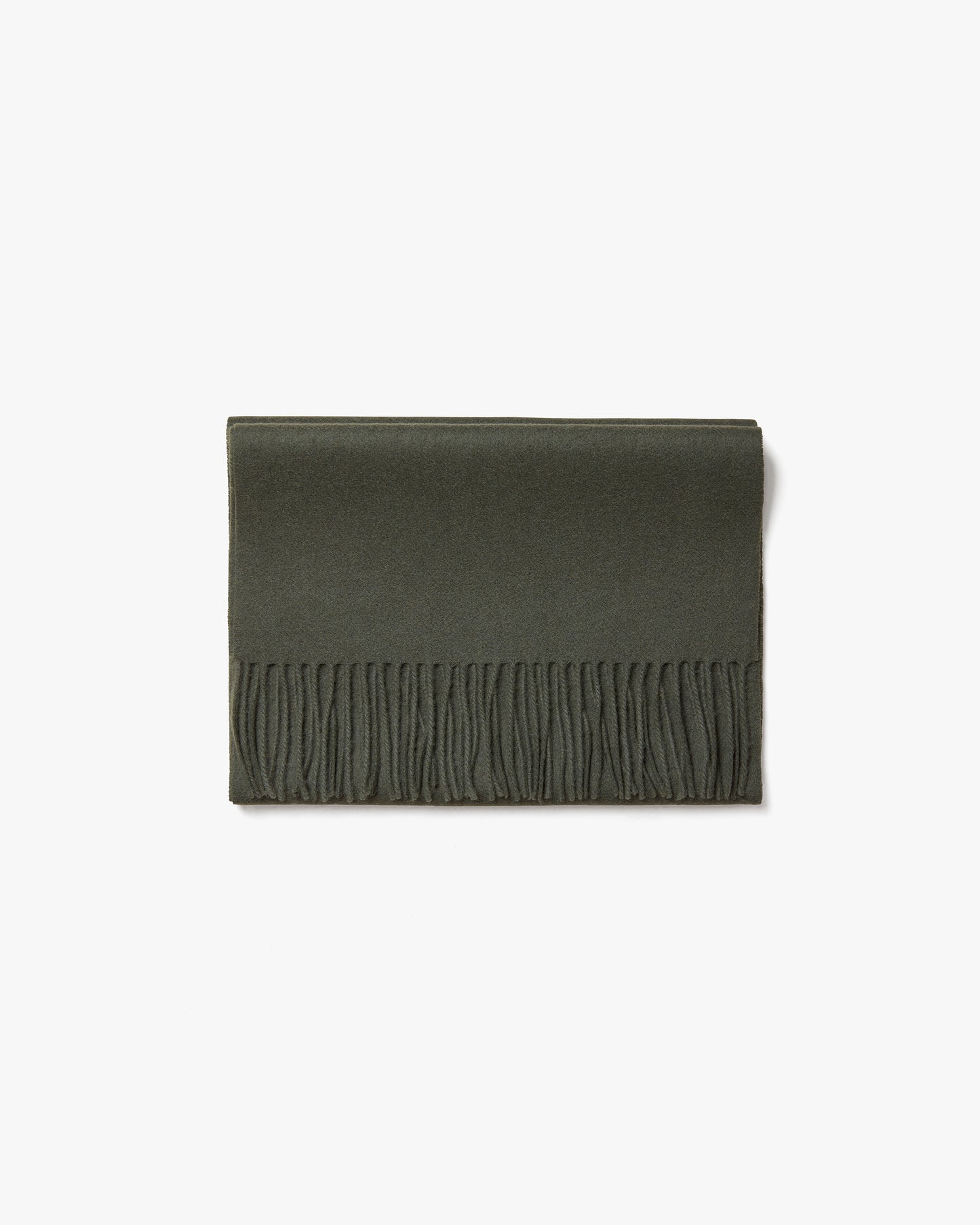 The Wool Scarf – Dark Green, neatly folded to display its texture and fringed edge against a white background.