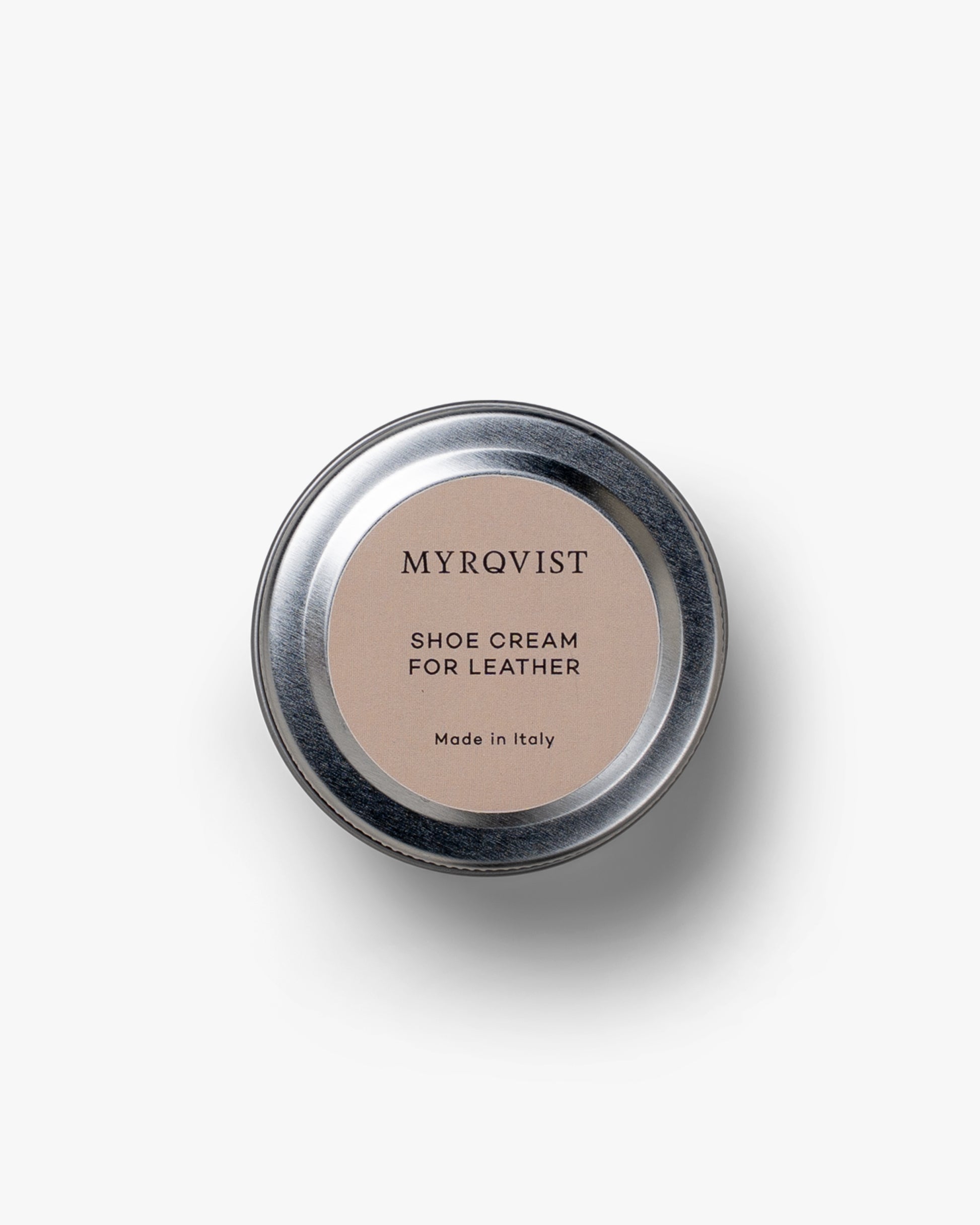 A top-down shot of the Myrqvist Shoe Cream tin, showing the branded lid against a clean white background.