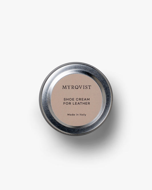 A top-down shot of the Myrqvist Shoe Cream tin, showing the branded lid against a clean white background.