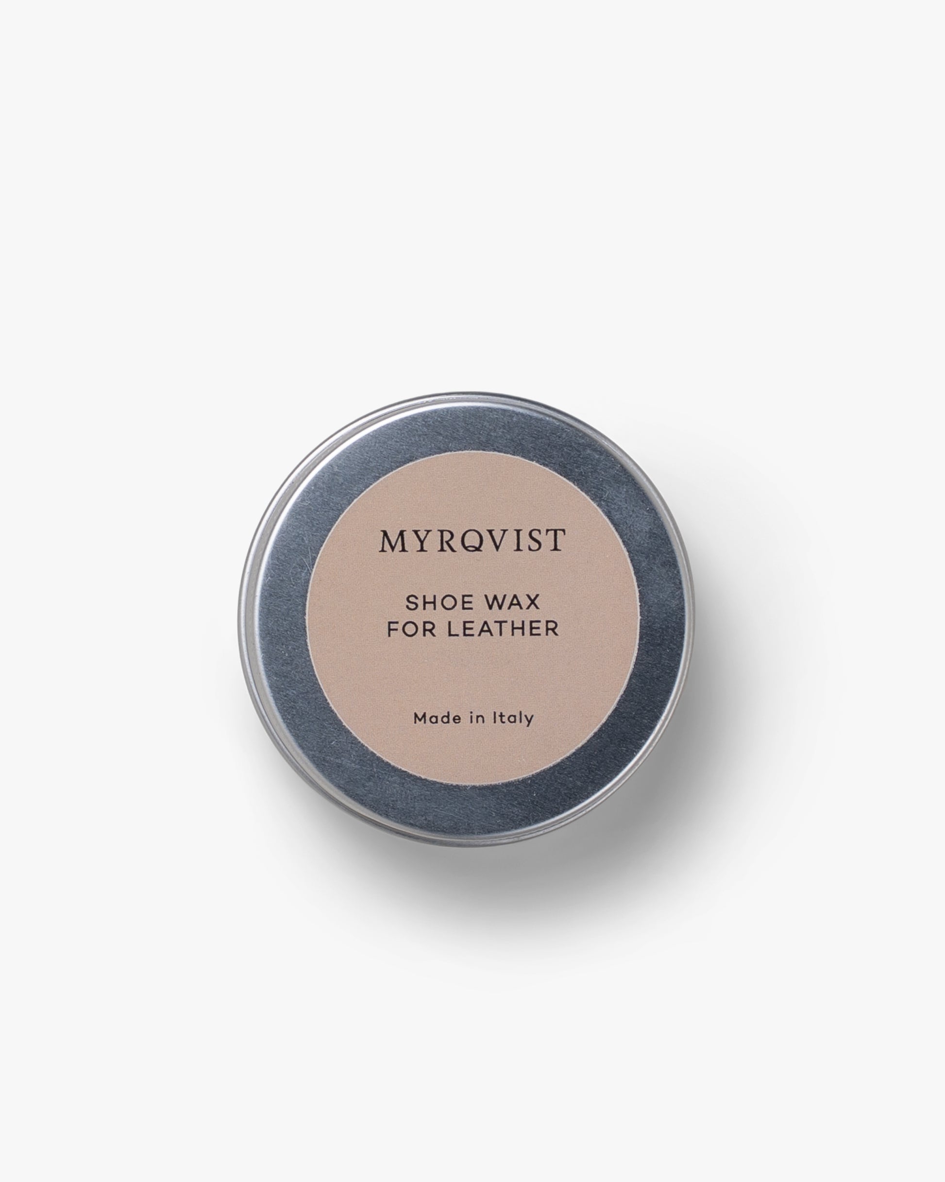 A top-down shot of the round, silver tin of Shoe Wax – Myrqvist.