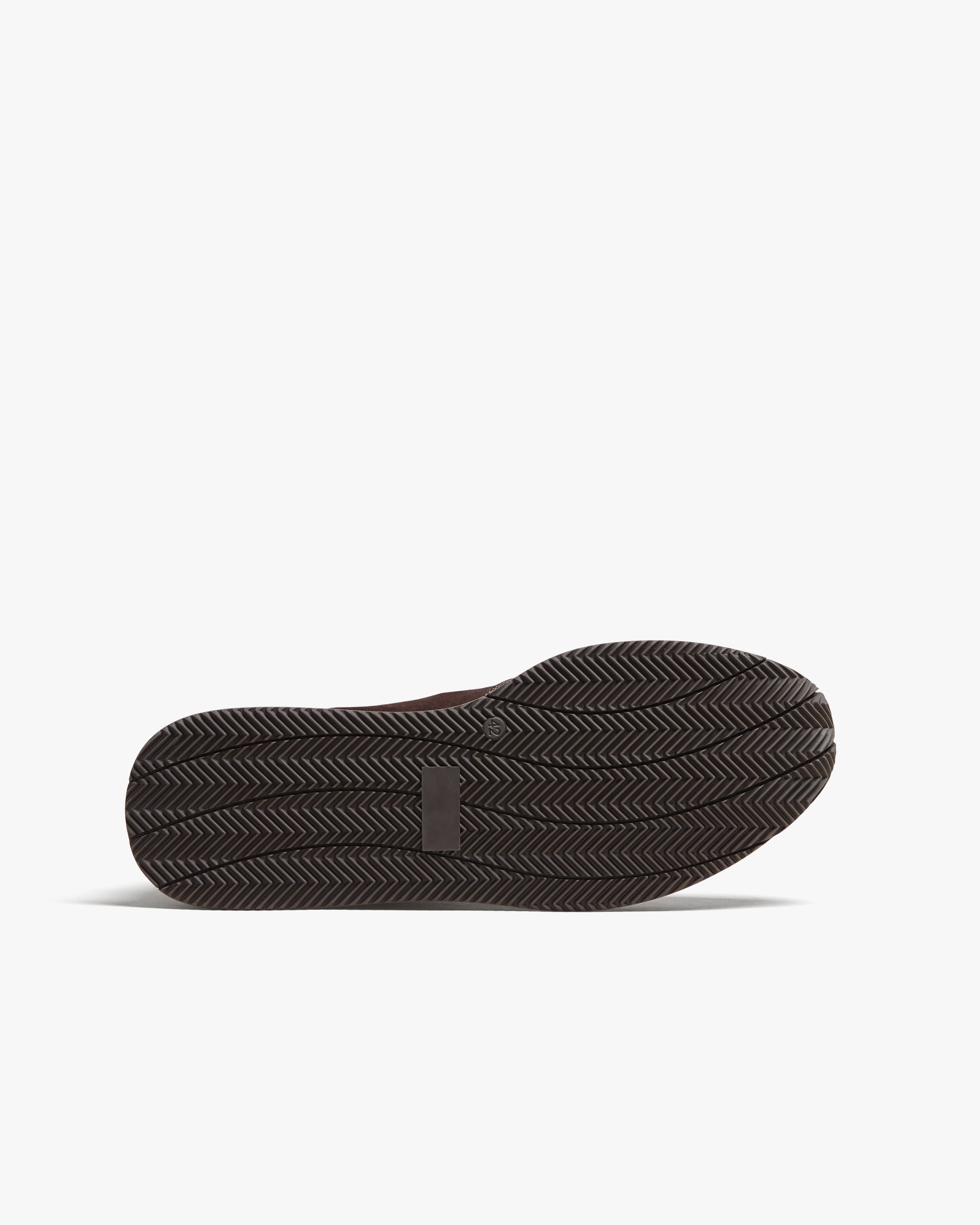 A close-up of the dark brown rubber sole of Stensund – Dark Brown Suede, showing its detailed tread pattern.