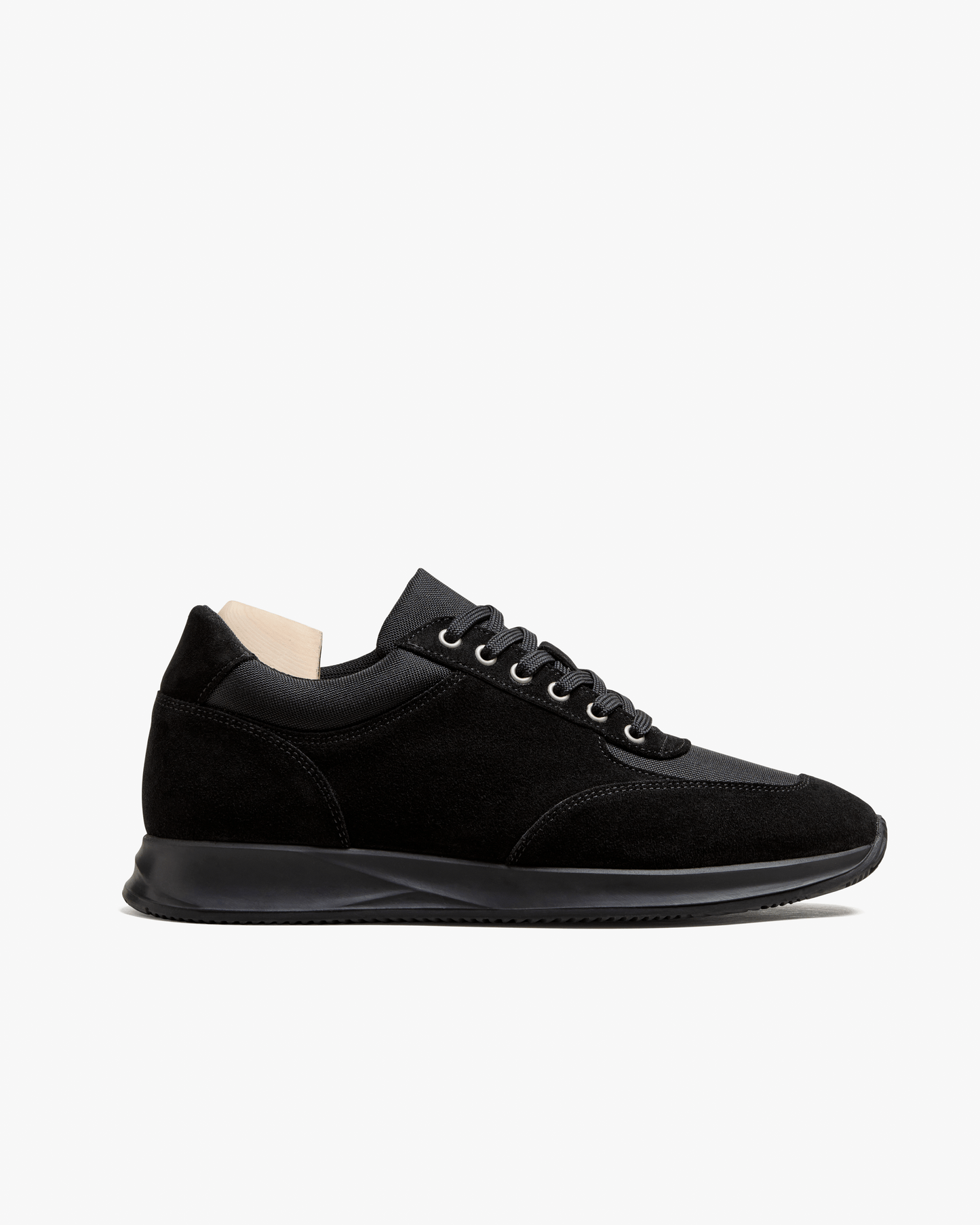 A side profile of the Stensund – Black Suede trainer, detailing the suede and mesh panels and the black rubber sole.