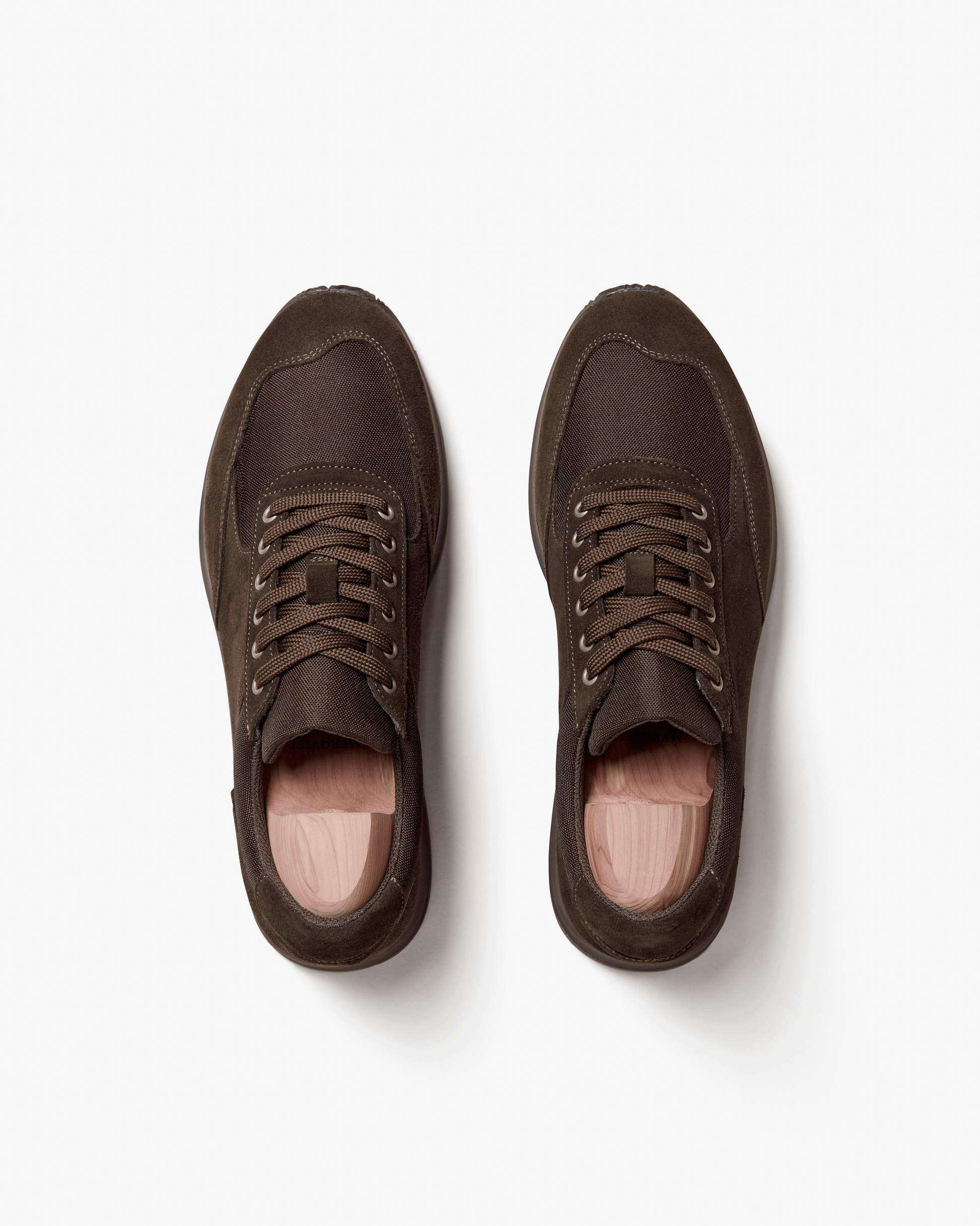 Top-down view of Stensund – Dark Brown Suede trainers with shoe trees, detailing the suede and mesh upper.
