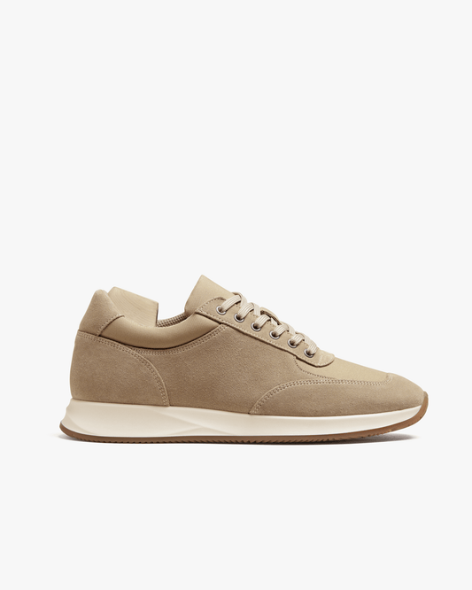 A side profile of the Stensund – Sand Suede trainer, pictured against a white background.