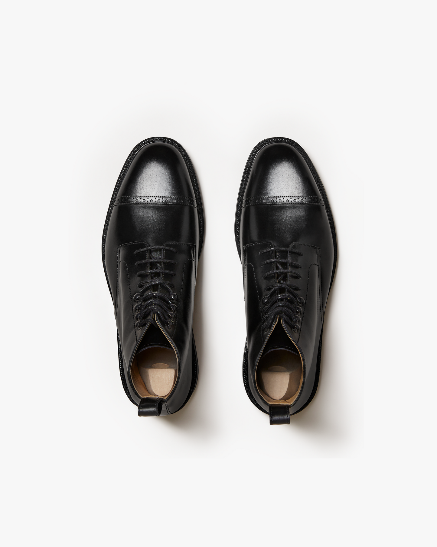 A top-down studio shot of Tjärnö – Black Calf jumper boots, highlighting the punched toe cap detailing.