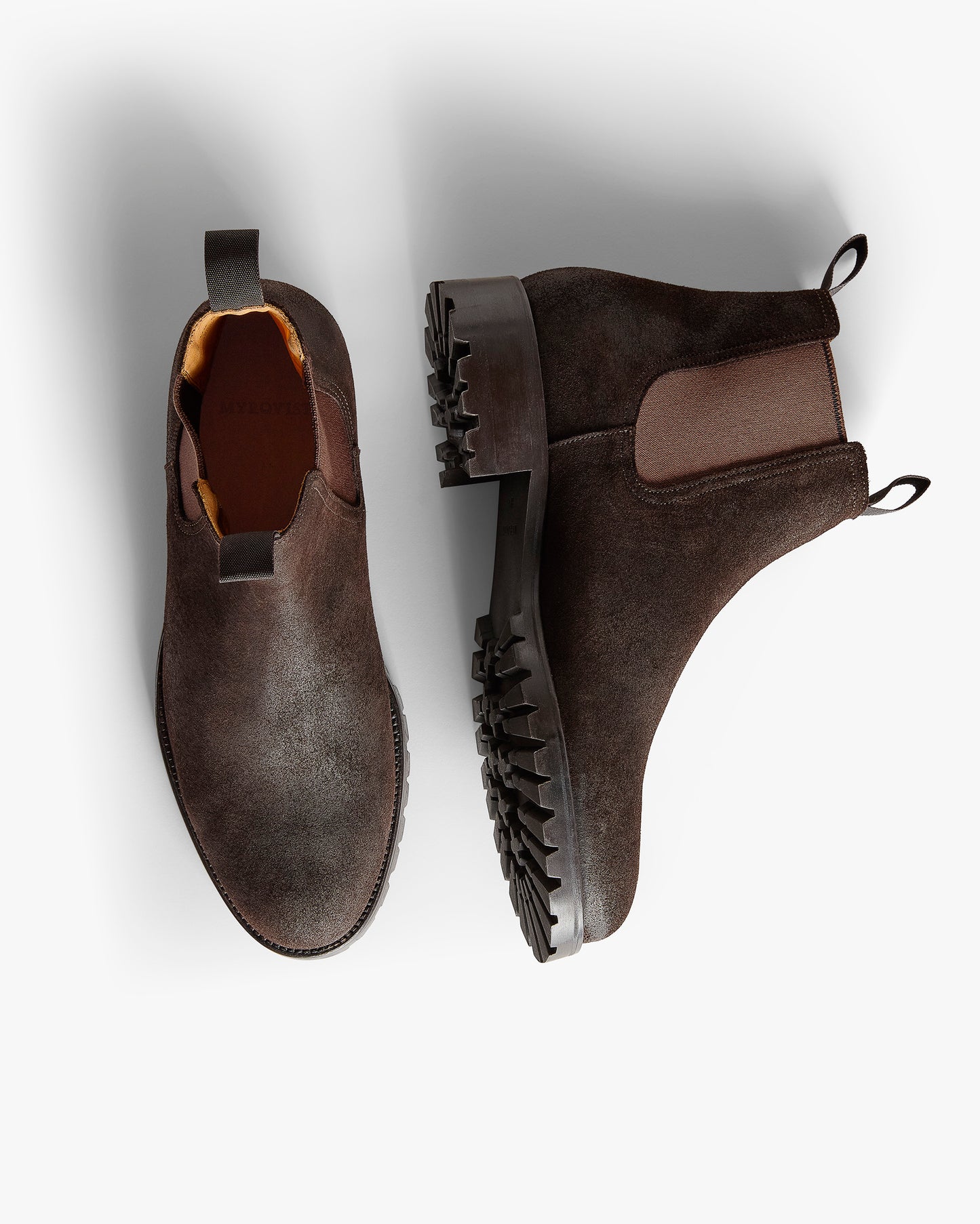 Elfvik II – Brown Waxed Suede shown with one Chelsea boot viewed from above and one showing the durable sole.