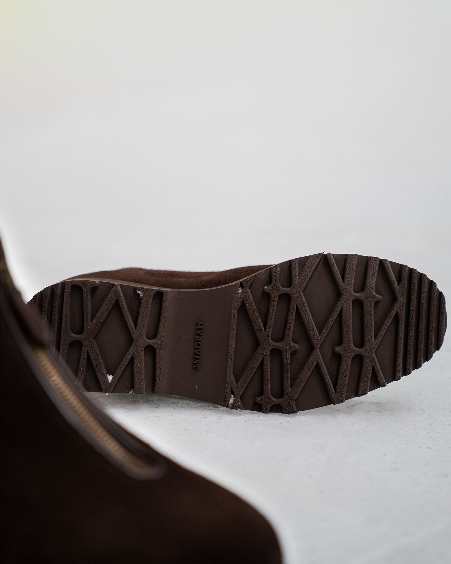 Bottom view of Funäs – Dark Brown Suede, showcasing the custom Explorer Sole with its distinct geometric tread.