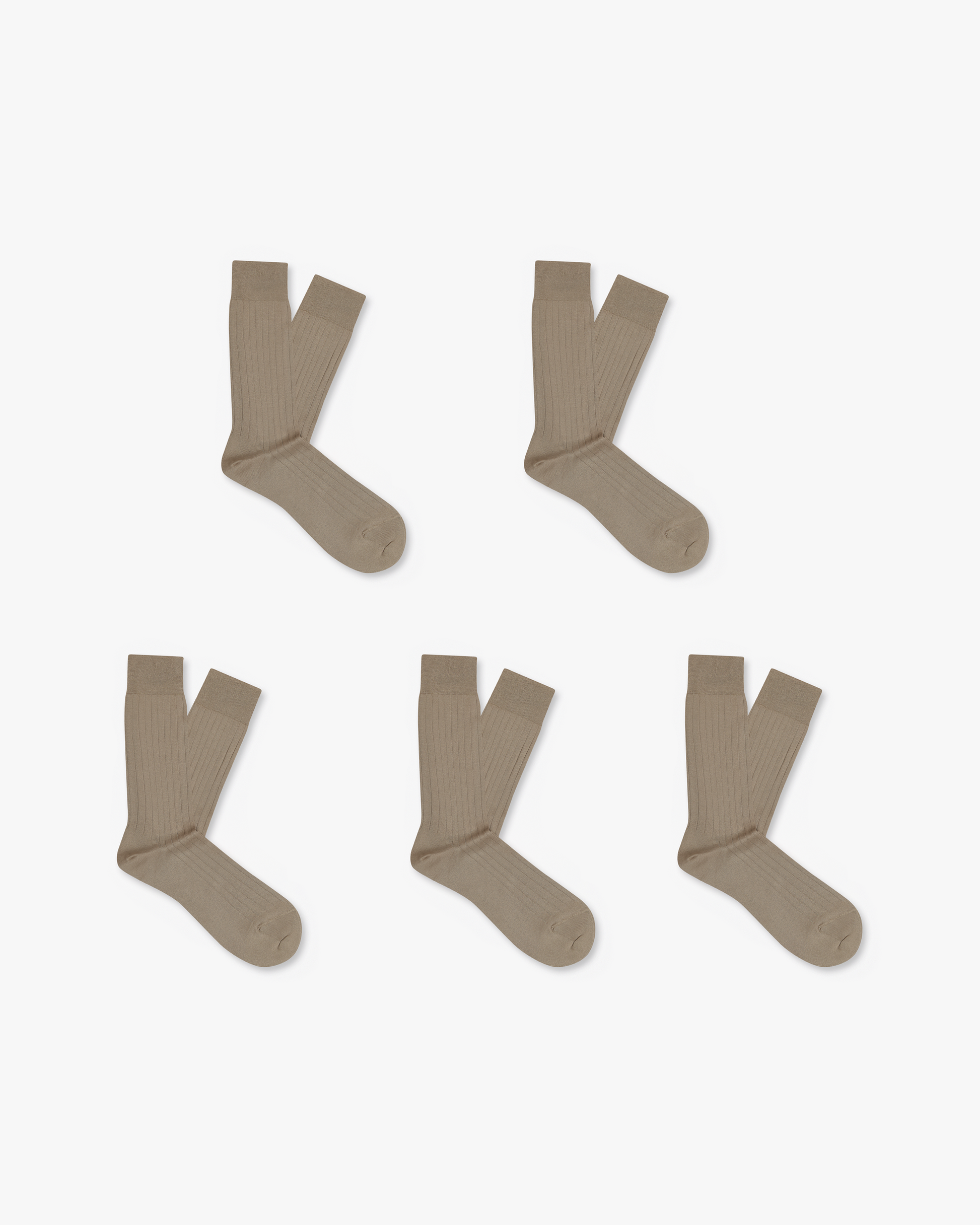 A flat lay of five pairs of Axel beige ribbed cotton socks against a white background.