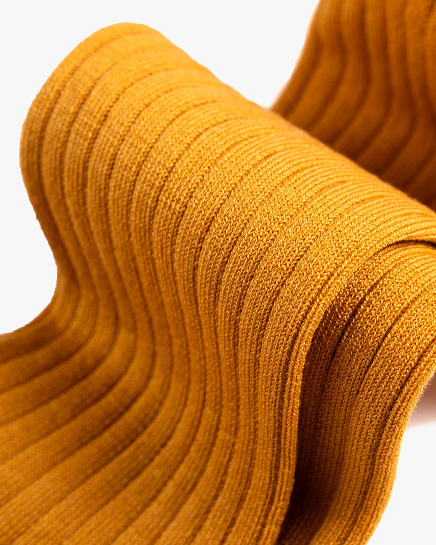 A detailed close-up of the ribbed texture on Nils – Knee-High Cotton Socks – Mustard Yellow.