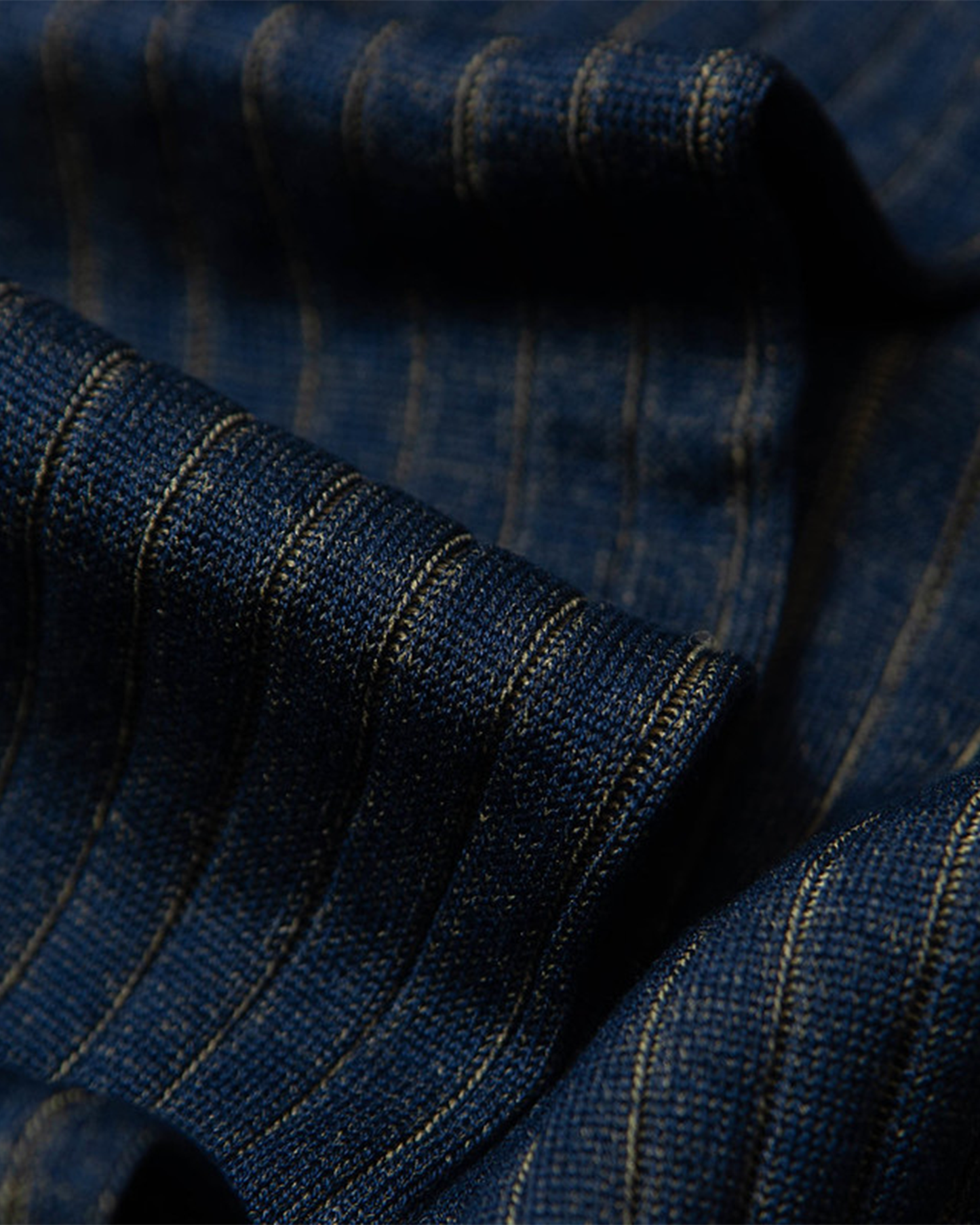 A close-up of Erik – Knee-High Cotton Socks – Yellow, detailing the finely ribbed texture in blue and yellow cotton.