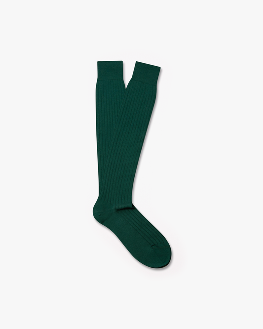 A pair of Gustav – Knee-High Merino Socks in forest green, against a white background.