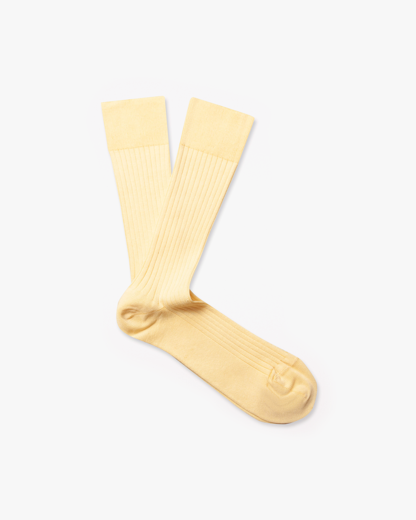 A pair of ribbed Axel – Cotton Socks in Pineapple Yellow laid flat on a white background.