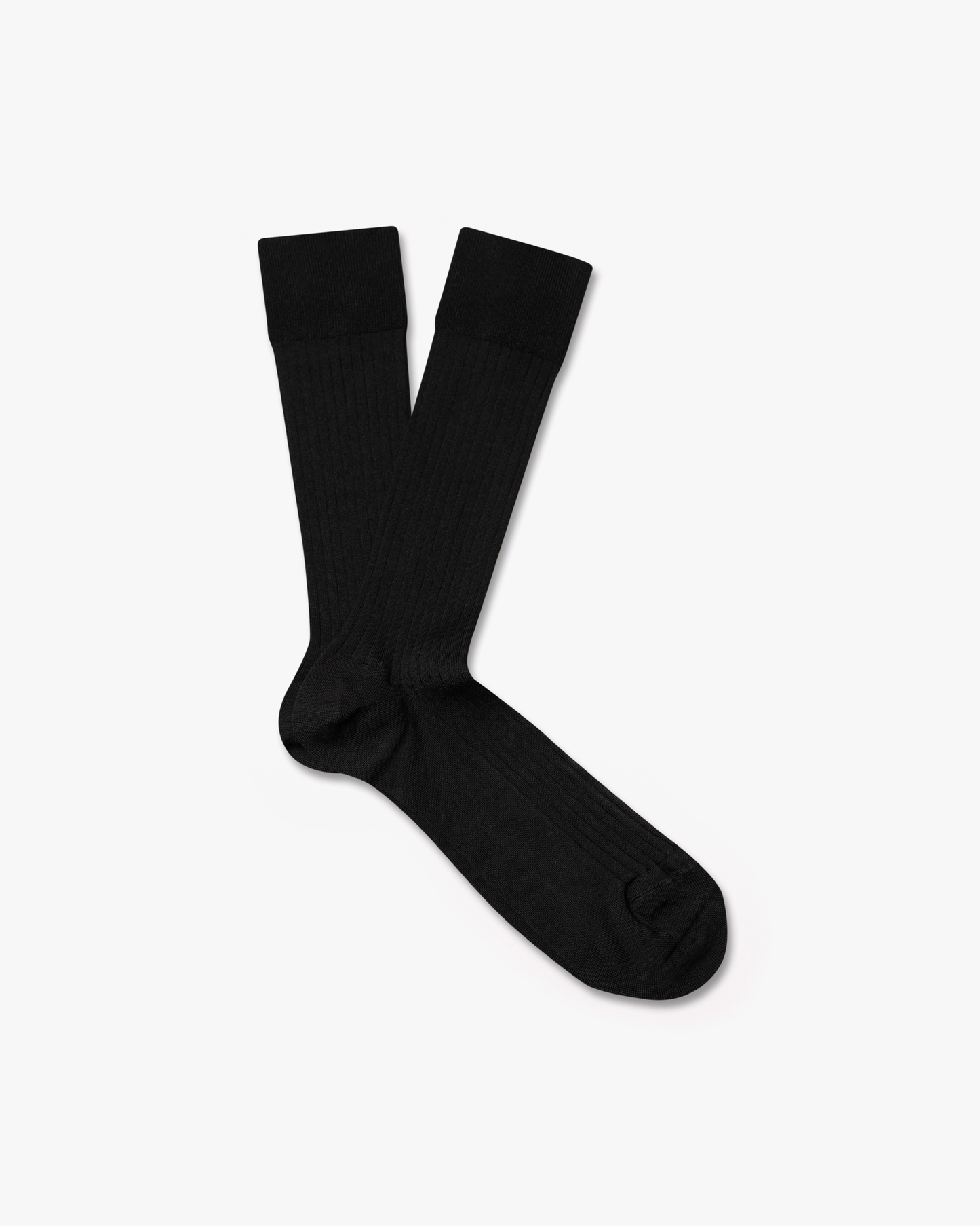 A pair of black, ribbed Axel – Cotton Socks laid flat on a white background.