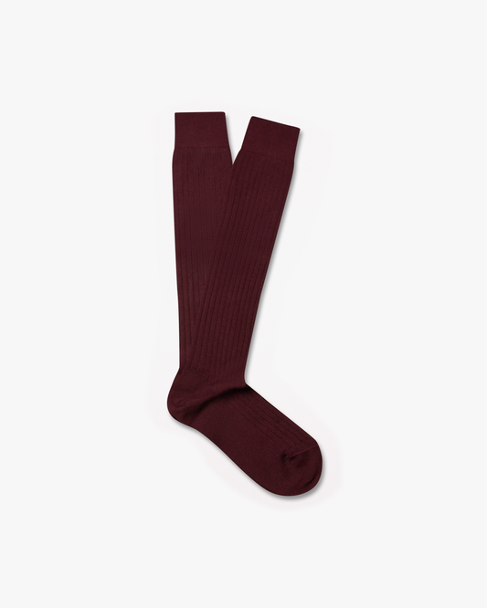 A pair of Nils – Knee-High Cotton Socks – Burgundy, laid flat against a white background.