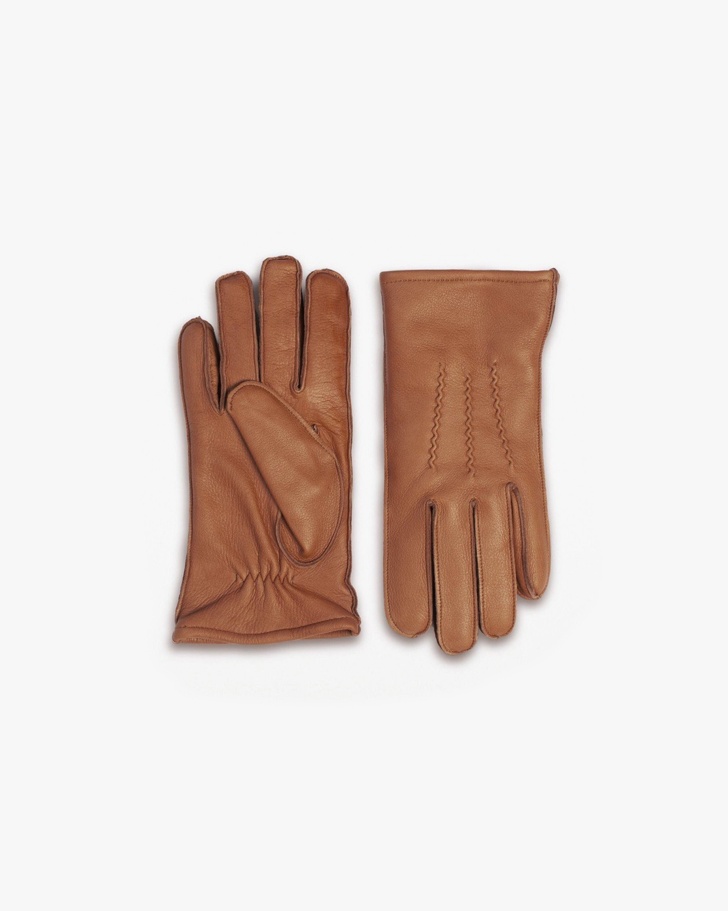 A pair of Gloves – Cognac Deer Leather on a white background, one showing the stitched back and the other the palm.